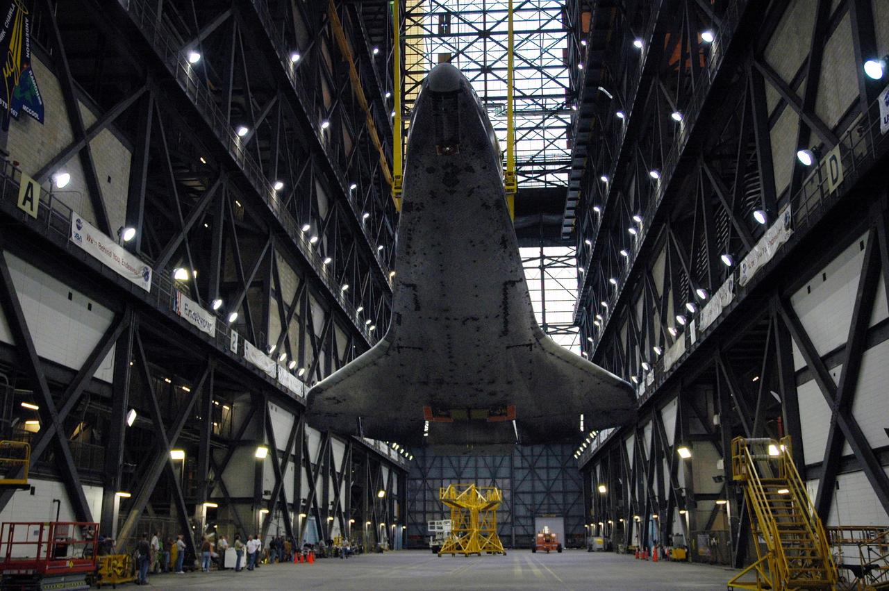 KENNEDY SPACE CENTER, FLA. --   The orbiter Endeavour hangs above the transfer aisle of the Vehicle Assembly Building.  The attached sling will raise it to vertical and lift it into the upper levels of the VAB. Then it will be moved to high bay 1 and stacked with the e1ternal tank and solid rocket boosters on the mobile launcher platform.  Endeavour will be launched on mission STS-118, its first flight in more than four years. The shuttle has undergone e1tensive modifications, including the addition of safety upgrades already added to shuttles Discovery and Atlantis. Endeavour also features new hardware, such as the Station-to-Shuttle Power Transfer System that will allow the docked shuttle to draw electrical power from the station and e1tend its visits to the orbiting lab.  Endeavour is targeted for launch on Aug. 7.     Photo credit: NASA/Charisse Nahser