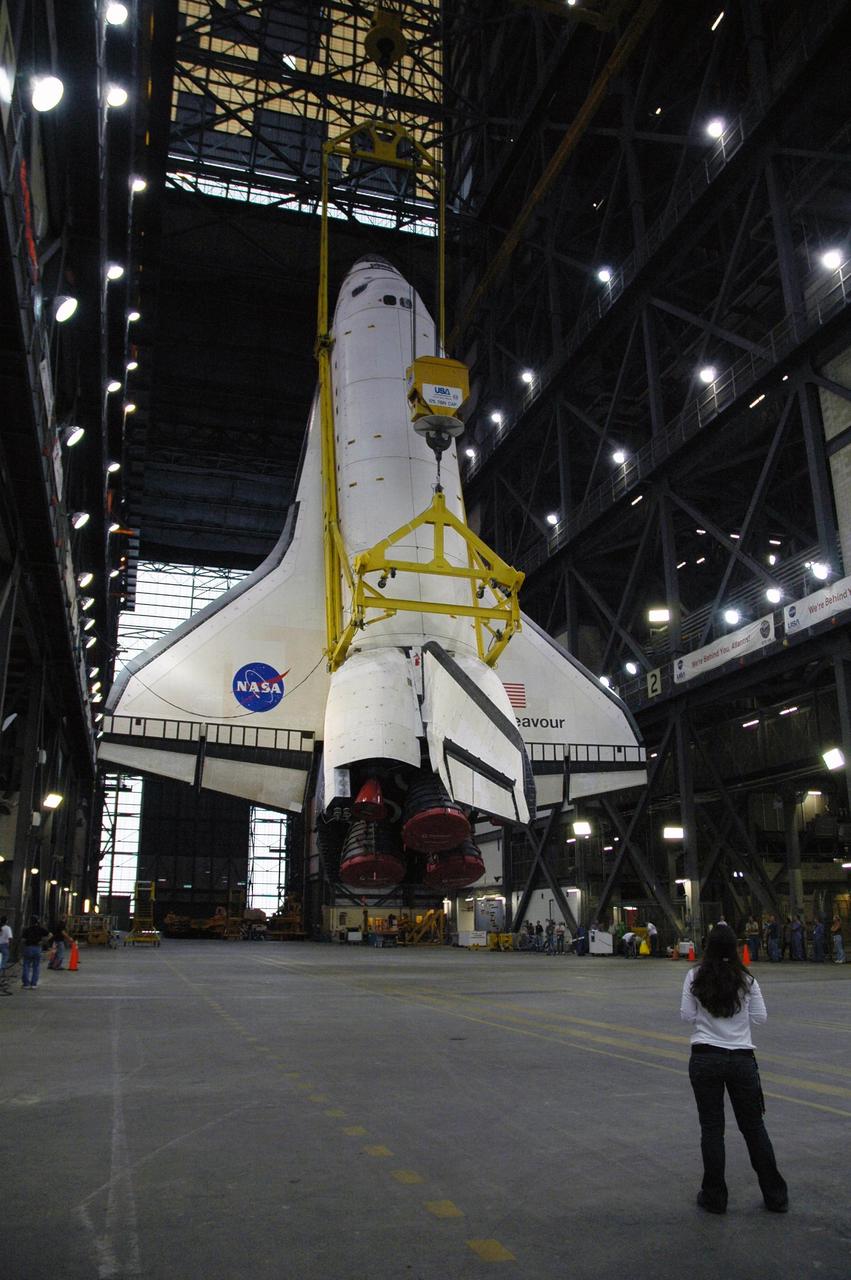 KENNEDY SPACE CENTER, FLA. --   The orbiter Endeavour hangs nearly vertical above the transfer aisle of the Vehicle Assembly Building.  It will be lifted into the upper levels of the VAB, moved to high bay 1 and stacked with the e1ternal tank and solid rocket boosters on the mobile launcher platform.  Endeavour will be launched on mission STS-118, its first flight in more than four years. The shuttle has undergone e1tensive modifications, including the addition of safety upgrades already added to shuttles Discovery and Atlantis. Endeavour also features new hardware, such as the Station-to-Shuttle Power Transfer System that will allow the docked shuttle to draw electrical power from the station and e1tend its visits to the orbiting lab.  Endeavour is targeted for launch on Aug. 7.     Photo credit: NASA/Charisse Nahser