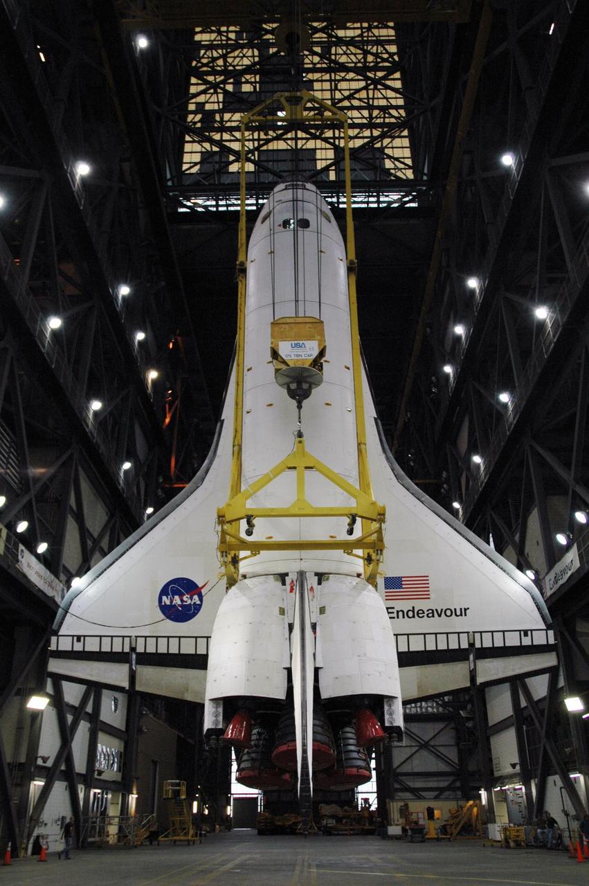 KENNEDY SPACE CENTER, FLA. --   The orbiter Endeavour hangs vertically above the transfer aisle of the Vehicle Assembly Building.  It will be lifted into the upper levels of the VAB, moved to high bay 1 and stacked with the e1ternal tank and solid rocket boosters on the mobile launcher platform.  Endeavour will be launched on mission STS-118, its first flight in more than four years. The shuttle has undergone e1tensive modifications, including the addition of safety upgrades already added to shuttles Discovery and Atlantis. Endeavour also features new hardware, such as the Station-to-Shuttle Power Transfer System that will allow the docked shuttle to draw electrical power from the station and e1tend its visits to the orbiting lab.  Endeavour is targeted for launch on Aug. 7.     Photo credit: NASA/Charisse Nahser