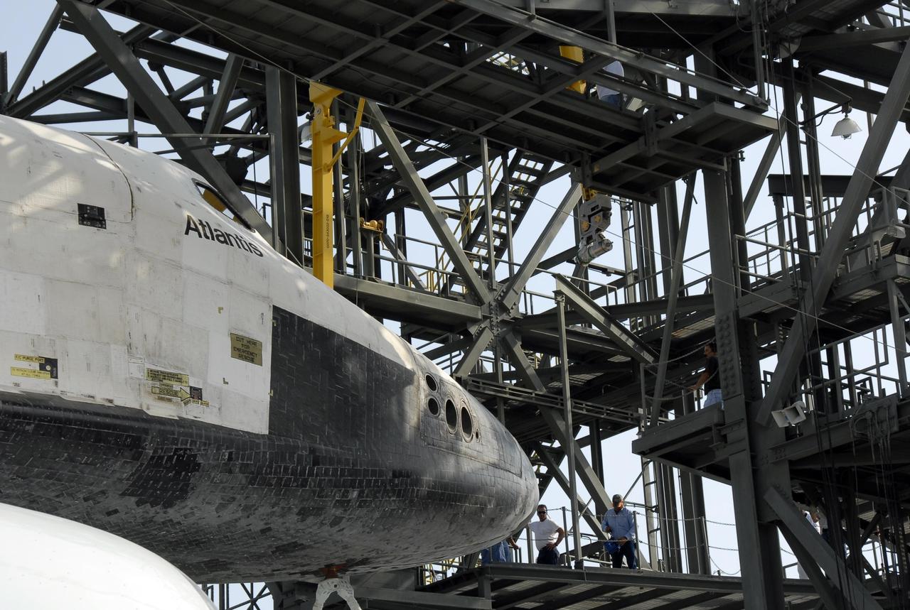 KENNEDY SPACE CENTER, FLA. --  On the KSC Shuttle Landing Facility, the shuttle carrier aircraft, or SCA, with the orbiter Atlantis on its back is towed under the mate/demate device.  The orbiter will be detached from the SCA and lowered onto a transporter.  Then Atlantis will be towed to the Orbiter Processing Facility to begin processing for its next launch, mission STS-122 in December.  Atlantis landed at Edwards Air Force Base in California on June 22 to end mission STS-117.  It returned to Kennedy atop the SCA on July 3 after a three-day, cross-country flight due to fuel stops and weather delays. Touchdown was at 8:27 a.m. EDT. Photo credit: NASA/Kim Shiflett