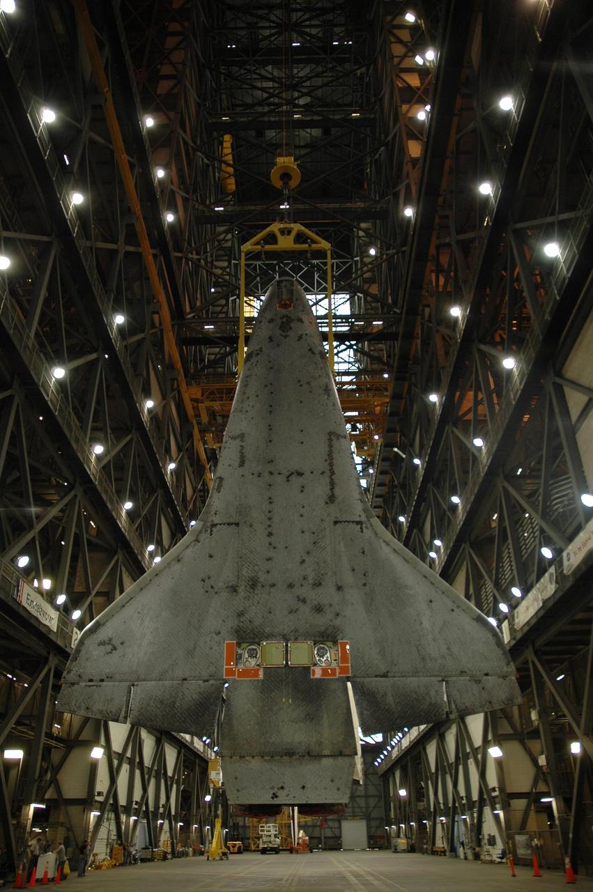 KENNEDY SPACE CENTER, FLA.  --  Seen from the back side, the orbiter Endeavour hangs vertically above the transfer aisle of the Vehicle Assembly Building.  It will be lifted into the upper levels of the Vehicle Assembly Building , moved laterally over a crossbeam to high bay 1 and stacked with the external tank and solid rocket boosters on the mobile launcher platform.  Endeavour will be launched on mission STS-118, its first flight in more than four years. The shuttle has undergone extensive modifications, including the addition of safety upgrades already added to shuttles Discovery and Atlantis. Endeavour also features new hardware, such as the Station-to-Shuttle Power Transfer System that will allow the docked shuttle to draw electrical power from the station and extend its visits to the orbiting lab.  Endeavour is targeted for launch on Aug. 7.     Photo credit: NASA/Troy Cryder