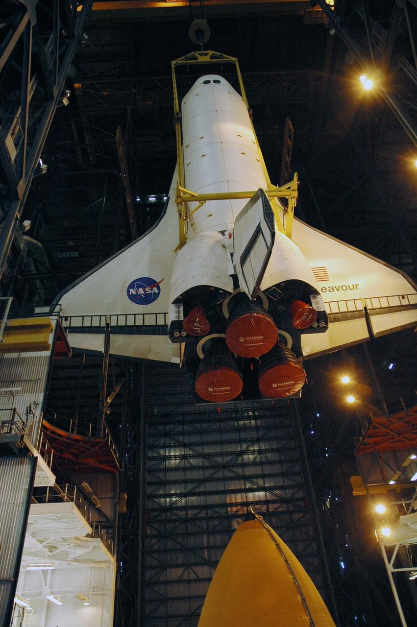 KENNEDY SPACE CENTER, FLA.  --  The orbiter Endeavour is lowered into high bay 1 of the Vehicle Assembly Building for stacking with the external tank (seen at the bottom) and solid rocket boosters on the mobile launcher platform.  Endeavour will be launched on mission STS-118, its first flight in more than four years. The shuttle has undergone extensive modifications, including the addition of safety upgrades already added to shuttles Discovery and Atlantis. Endeavour also features new hardware, such as the Station-to-Shuttle Power Transfer System that will allow the docked shuttle to draw electrical power from the station and extend its visits to the orbiting lab.  Endeavour is targeted for launch on Aug. 7.     Photo credit: NASA/Troy Cryder