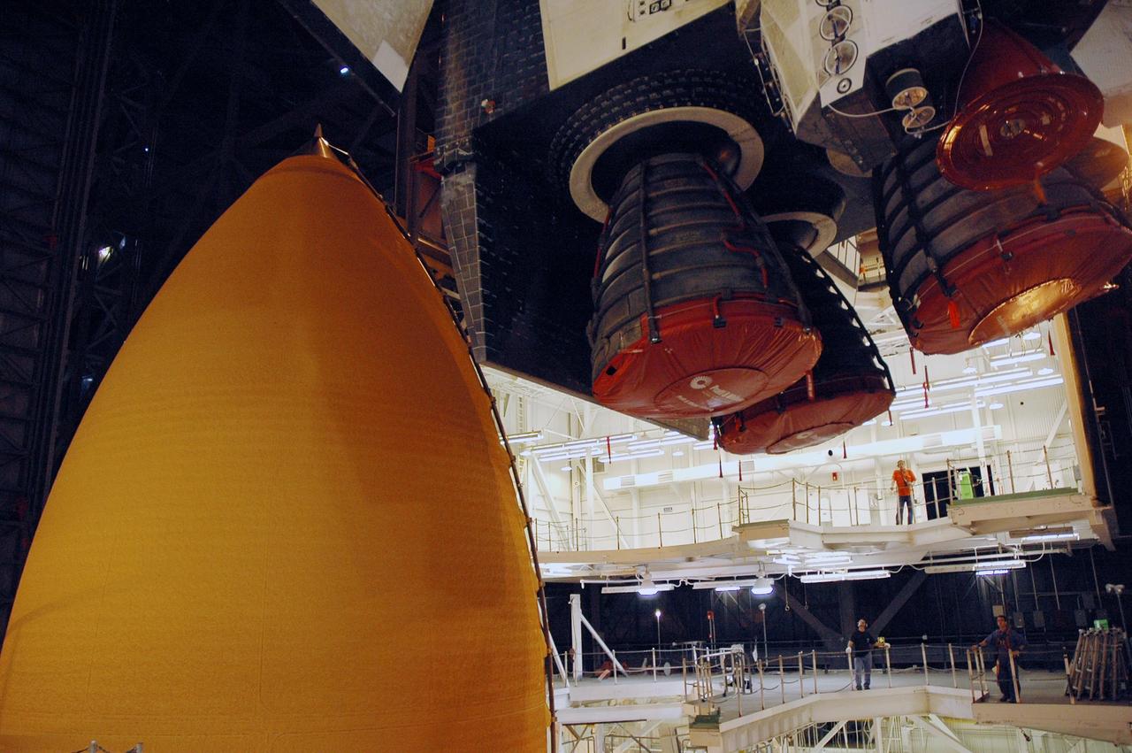 KENNEDY SPACE CENTER, FLA.  --  The main engines on the orbiter Endeavour (upper right) are seen as Endeavour is lowered into high bay 1 of the Vehicle Assembly Building for stacking with the external tank (seen at left) and solid rocket boosters on the mobile launcher platform.  Endeavour will be launched on mission STS-118, its first flight in more than four years. The shuttle has undergone extensive modifications, including the addition of safety upgrades already added to shuttles Discovery and Atlantis. Endeavour also features new hardware, such as the Station-to-Shuttle Power Transfer System that will allow the docked shuttle to draw electrical power from the station and extend its visits to the orbiting lab.  Endeavour is targeted for launch on Aug. 7.     Photo credit: NASA/Troy Cryder