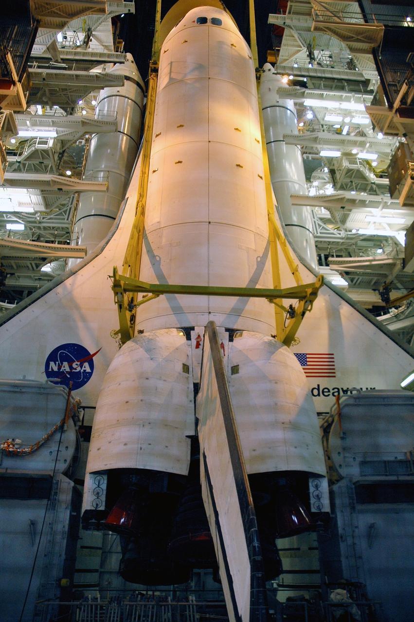 KENNEDY SPACE CENTER, FLA. --   In high bay 1 of the Vehicle Assembly Building, the orbiter Endeavour is lowered onto the mobile launcher platform.  The orbiter blocks the view of the external tank; on either side of the orbiter are the white solid rocket boosters.  The components will be mated for launch.  Endeavour will be launched on mission STS-118, its first flight in more than four years. The shuttle has undergone extensive modifications, including the addition of safety upgrades already added to shuttles Discovery and Atlantis. Endeavour also features new hardware, such as the Station-to-Shuttle Power Transfer System that will allow the docked shuttle to draw electrical power from the station and extend its visits to the orbiting lab.  Endeavour is targeted for launch on Aug. 7.     Photo credit: NASA/Troy Cryder