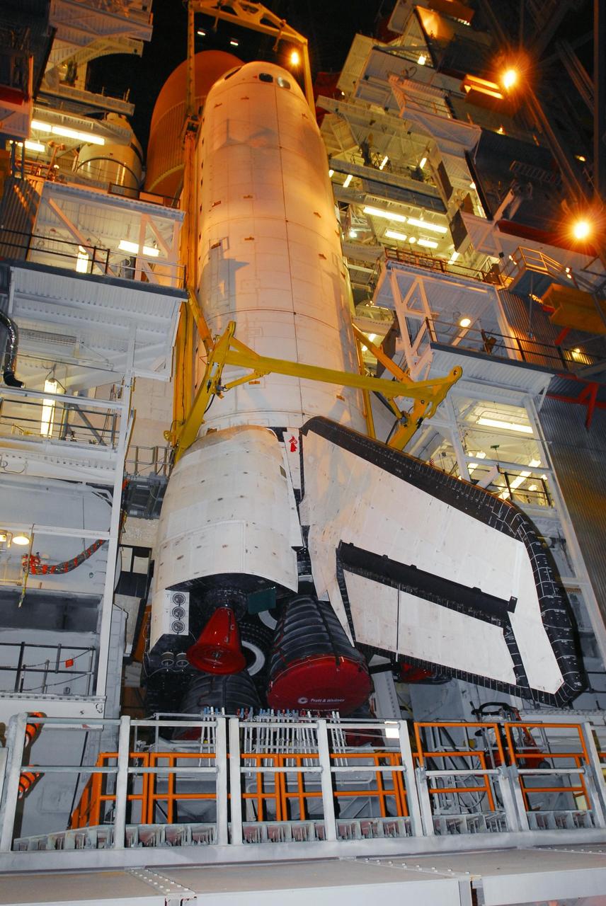 KENNEDY SPACE CENTER, FLA. --   In high bay 1 of the Vehicle Assembly Building, platforms surround Endeavour to complete stacking of the orbiter, external tank and solid rocket boosters, barely visible behind the platforms.  Endeavour will be launched on mission STS-118, its first flight in more than four years. The shuttle has undergone extensive modifications, including the addition of safety upgrades already added to shuttles Discovery and Atlantis. Endeavour also features new hardware, such as the Station-to-Shuttle Power Transfer System that will allow the docked shuttle to draw electrical power from the station and extend its visits to the orbiting lab.  Endeavour is targeted for launch on Aug. 7.     Photo credit: NASA/George Shelton