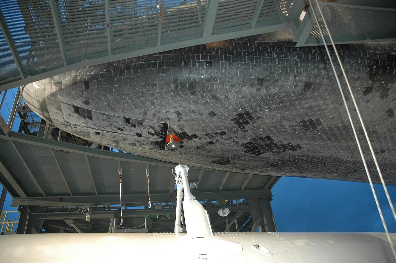 KENNEDY SPACE CENTER, FLA. -- At the mate/demate device at Kennedy Space Center's Shuttle Landing Facility, Atlantis is lifted up from the shuttle carrier aircraft, or SCA, beneath it. The orbiter will be lowered to the ground and then towed to the Orbiter Processing Facility to begin processing for its next launch, mission STS-122 in December. Atlantis arrived at Kennedy Space Center atop the SCA on July 3 after a three-day, cross-country flight due to fuel stops and weather delays. Touchdown was at 8:27 a.m. EDT. Atlantis landed at Edwards Air Force Base in California on June 22 to end mission STS-117. Photo credit: NASA/Jack Pfaller.