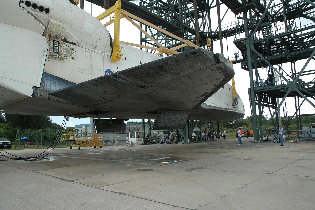 KENNEDY SPACE CENTER, FLA. --  Atlantis is slowly lowered to the ground at the mate/demate device at Kennedy Space Center's Shuttle Landing Facility. The orbiter will be detached from the lifting crane and then towed to the Orbiter Processing Facility to begin processing for its next launch, mission STS-122 in December. Atlantis arrived at Kennedy Space Center atop the SCA on July 3 after a three-day, cross-country flight due to fuel stops and weather delays. Touchdown was at 8:27 a.m. EDT. Atlantis landed at Edwards Air Force Base in California on June 22 to end mission STS-117.  Photo credit: NASA/Jack Pfaller.