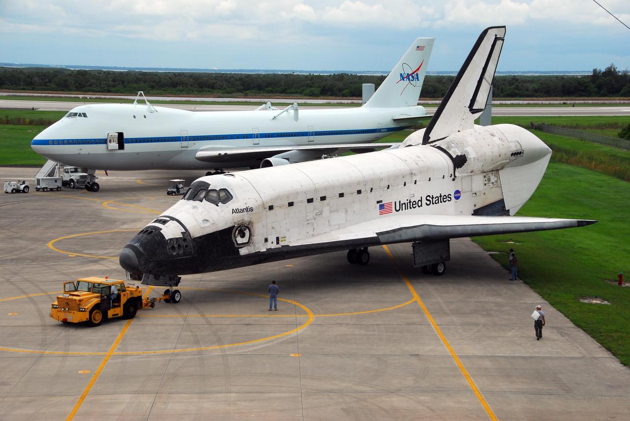 KENNEDY SPACE CENTER, FLA. -- Atlantis is towed back from the mate/demate device at Kennedy Space Center's Shuttle Landing Facility. The orbiter will be towed to the Orbiter Processing Facility, where processing will begin for its next launch, mission STS-122 in December. Visible on Atlantis is the tail cone that covers and protects the main engines during the ferry flight. Atlantis arrived at Kennedy Space Center atop the SCA on July 3 after a three-day, cross-country flight due to fuel stops and weather delays. Touchdown was at 8:27 a.m. EDT. Atlantis landed at Edwards Air Force Base in California on June 22 to end mission STS-117. Photo credit: NASA/George Shelton.