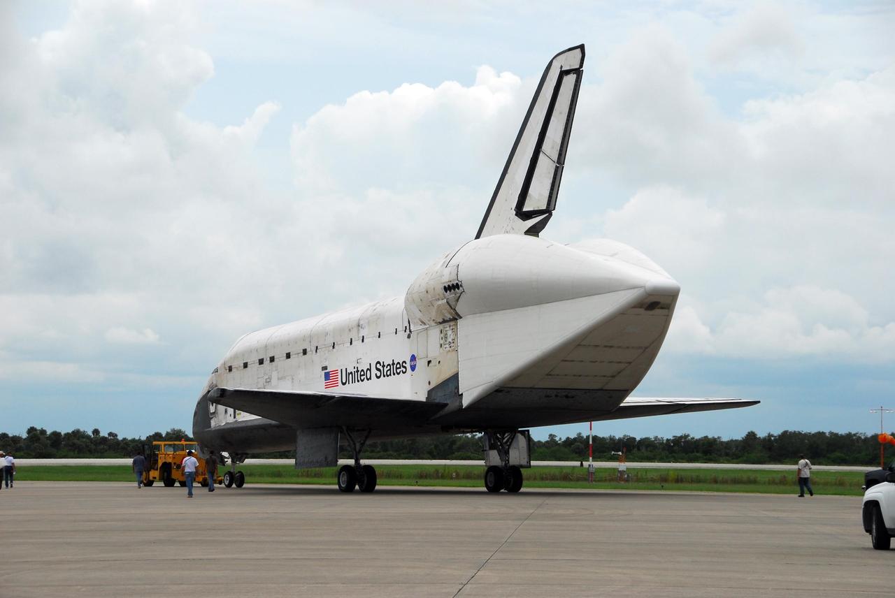 KENNEDY SPACE CENTER, FLA. -- After demate from the shuttle carrier aircraft, or SCA, Atlantis begins its trek from Kennedy Space Center's Shuttle Landing Facility to the Orbiter Processing Facility. The orbiter will undergo processing for its next launch, mission STS-122 in December. Visible on Atlantis is the tail cone that covers and protects the main engines during the ferry flight. Atlantis arrived at Kennedy Space Center atop the SCA on July 3 after a three-day, cross-country flight due to fuel stops and weather delays. Touchdown was at 8:27 a.m. EDT. Atlantis landed at Edwards Air Force Base in California on June 22 to end mission STS-117. Photo credit: NASA/George Shelton.