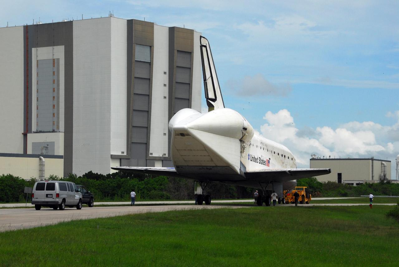 KENNEDY SPACE CENTER, FLA. -- Atlantis is towed toward the Orbiter Processing Facility from the Shuttle Landing Facility at Kennedy Space Center. The orbiter will undergo processing for its next launch, mission STS-122 in December. Visible on Atlantis is the tail cone that covers and protects the main engines during the ferry flight. The massive Vehicle Assembly Building can be seen to the left. Atlantis arrived at Kennedy Space Center atop the SCA on July 3 after a three-day, cross-country flight due to fuel stops and weather delays. Touchdown was at 8:27 a.m. EDT. Atlantis landed at Edwards Air Force Base in California on June 22 to end mission STS-117. Photo credit: NASA/George Shelton.