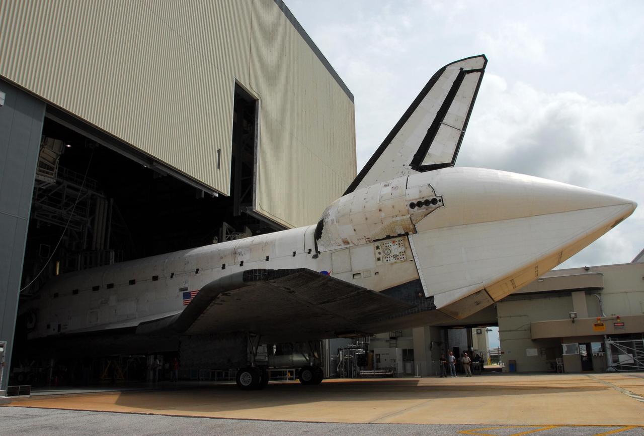 KENNEDY SPACE CENTER, FLA. -- Atlantis is towed into the Orbiter Processing Facility. The orbiter will undergo processing for its next launch, mission STS-122 in December. Visible on Atlantis is the tail cone that covers and protects the main engines during the ferry flight. Atlantis arrived at Kennedy Space Center atop the SCA on July 3 after a three-day, cross-country flight due to fuel stops and weather delays. Touchdown was at 8:27 a.m. EDT. Atlantis landed at Edwards Air Force Base in California on June 22 to end mission STS-117. Photo credit: NASA/George Shelton.