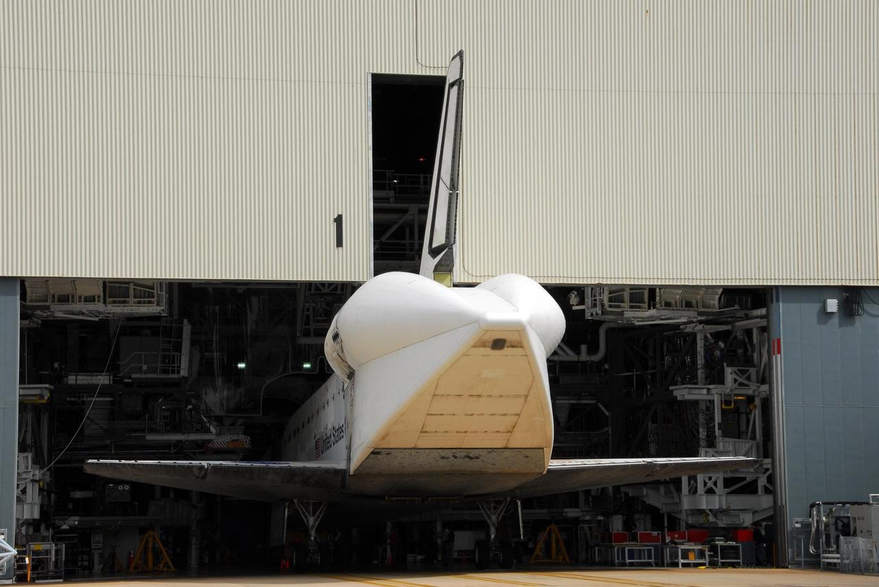KENNEDY SPACE CENTER, FLA. -- Atlantis is towed into the Orbiter Processing Facility, completing its journey from the Shuttle Landing Facility. The orbiter will undergo processing for its next launch, mission STS-122 in December. Visible on Atlantis is the tail cone that covers and protects the main engines during the ferry flight. Atlantis arrived at Kennedy Space Center atop the SCA on July 3 after a three-day, cross-country flight due to fuel stops and weather delays. Touchdown was at 8:27 a.m. EDT. Atlantis landed at Edwards Air Force Base in California on June 22 to end mission STS-117. Photo credit: NASA/George Shelton.