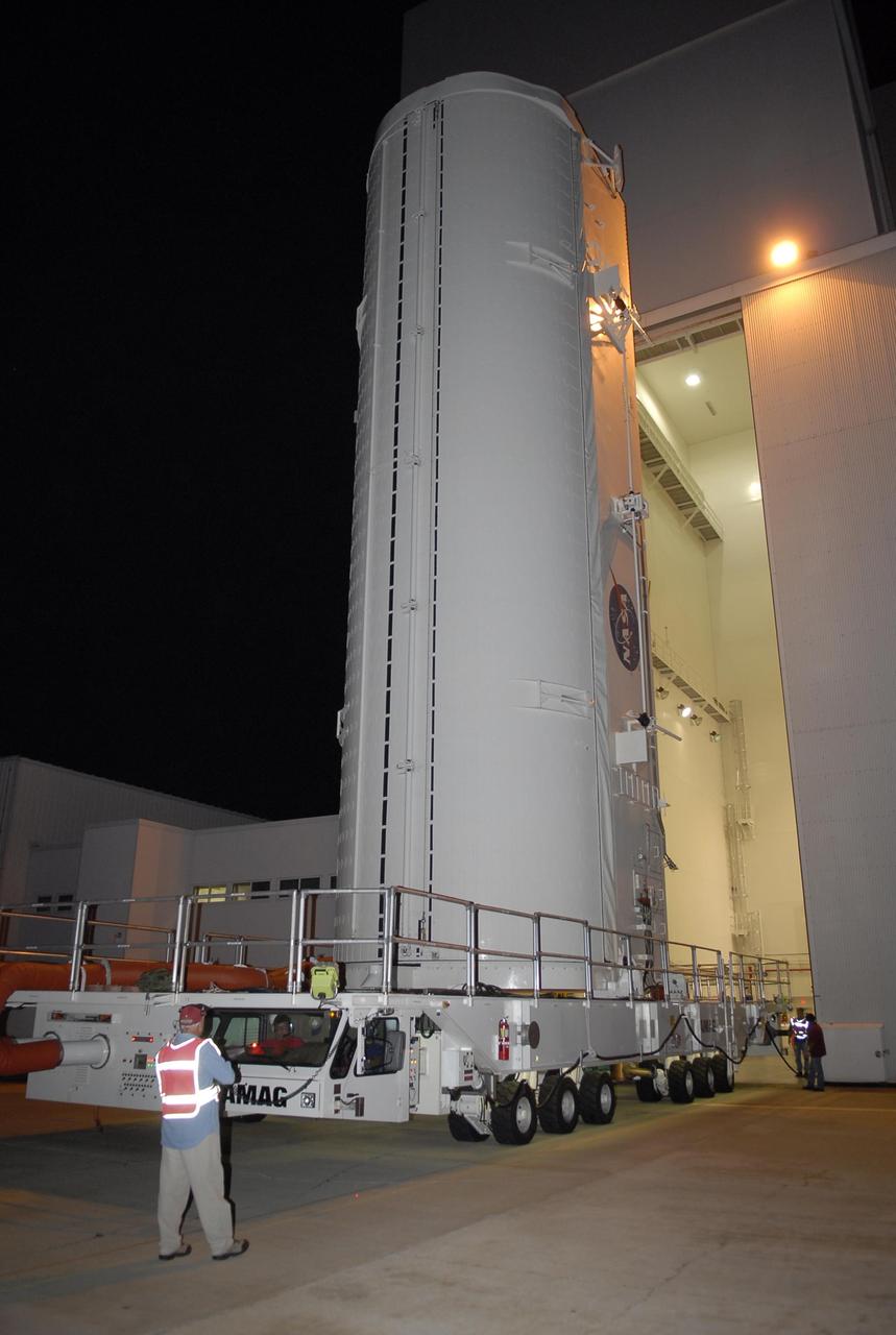 KENNEDY SPACE CENTER, FLA. -- The payload canister on its transporter leaves the Vertical Processing Facility. Inside the canister are the S5 truss, SPACEHAB module and external stowage platform 3, the payload for mission STS-118. They will be placed in the payload bay on Space Shuttle Endeavour when it arrives at the pad. The mission will be Endeavour's first flight in more than four years. The shuttle has undergone extensive modifications, including the addition of safety upgrades already added to shuttles Discovery and Atlantis. Endeavour also features new hardware, such as the Station-to-Shuttle Power Transfer System that will allow the docked shuttle to draw electrical power from the station and extend its visits to the orbiting lab. Space Shuttle Endeavour is targeted for launch on Aug. 7 from Launch Pad 39A. Photo credit: NASA/Kim Shiflett