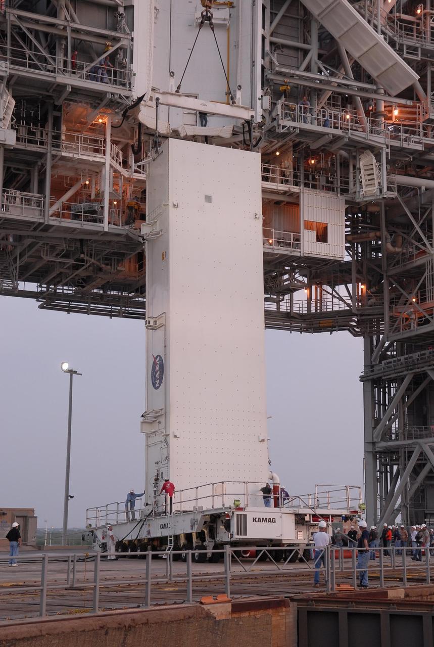 KENNEDY SPACE CENTER, FLA. --   On Launch Pad 39A, the payload canister is prepared for lifting.  Inside the canister are the S5 truss, SPACEHAB module and external stowage platform 3, the payload for mission STS-118.  The canister will be lifted up to the payload changeout room above and the payloads transferred inside to wait for Space Shuttle Endeavour to arrive at the pad.  The changeout room is the enclosed, environmentally controlled portion of the rotating service structure that supports cargo delivery to the pad and subsequent vertical installation into the orbiter payload bay.  The mission will be Endeavour's first flight in more than four years. The shuttle has undergone extensive modifications, including the addition of safety upgrades already added to shuttles Discovery and Atlantis. Endeavour also features new hardware, such as the Station-to-Shuttle Power Transfer System that will allow the docked shuttle to draw electrical power from the station and extend its visits to the orbiting lab.  Space Shuttle Endeavour is targeted for launch on Aug. 7 from Launch Pad 39A.   Photo credit: NASA/Kim Shiflett