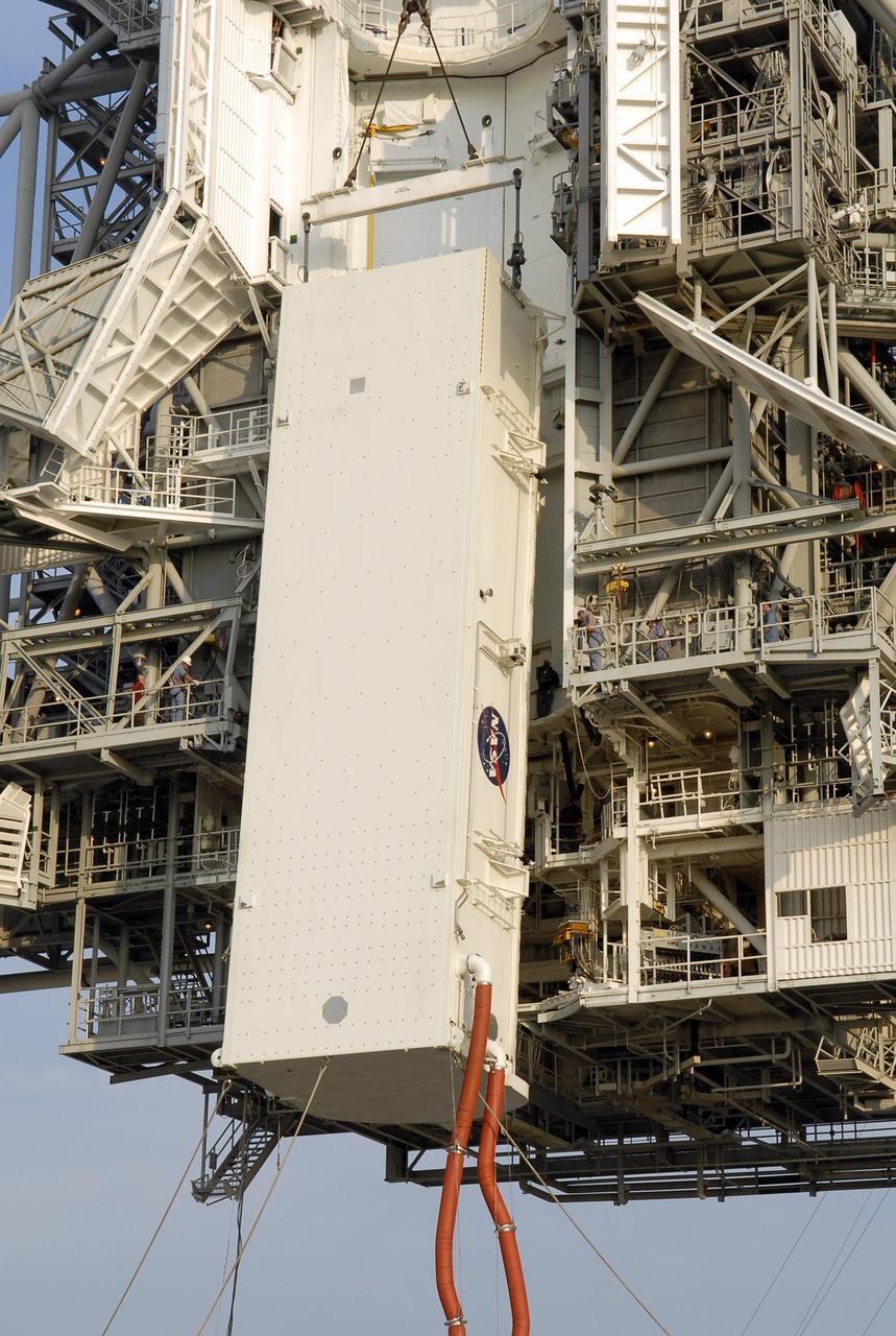 KENNEDY SPACE CENTER, FLA. -- On Launch Pad 39A, the payload canister is lifted up to the payload changeout room. Inside the canister are the S5 truss, SPACEHAB module and external stowage platform 3, the payload for mission STS-118. The red umbilical lines are still attached. The payloads will be transferred inside the changeout room to wait for Space Shuttle Endeavour to arrive at the pad. The changeout room is the enclosed, environmentally controlled portion of the rotating service structure that supports cargo delivery to the pad and subsequent vertical installation into the orbiter payload bay. The mission will be Endeavour's first flight in more than four years. The shuttle has undergone extensive modifications, including the addition of safety upgrades already added to shuttles Discovery and Atlantis. Endeavour also features new hardware, such as the Station-to-Shuttle Power Transfer System that will allow the docked shuttle to draw electrical power from the station and extend its visits to the orbiting lab. Space Shuttle Endeavour is targeted for launch on Aug. 7 from Launch Pad 39A. Photo credit: NASA/Kim Shiflett