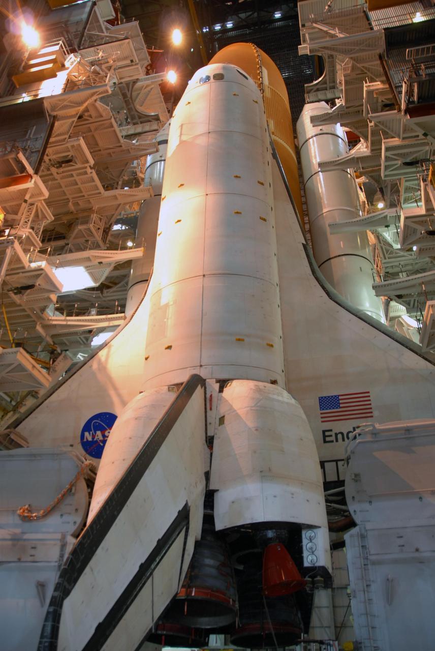 KENNEDY SPACE CENTER, FLA. --   Lights from above bathe Space Shuttle Endeavour in a soft glow as it sits in the Vehicle Assembly Building waiting for rollout to Launch Pad 39A.  Visible behind the orbiter are the white solid rocket boosters at each side of the external tank. The shuttle assembly rests on the mobile launcher platform, which will be lifted by the crawler-transporter for the slow journey to the pad.  Rollout was originally planned for just after midnight on July 10 but the move was canceled by NASA managers because unfavorable weather was predicted to arrive in the launch area before the vehicle would be secured at the pad.   Rollout is scheduled to begin again about 9 p.m. July 10.  Photo credit: NASA/Ken Thornsley