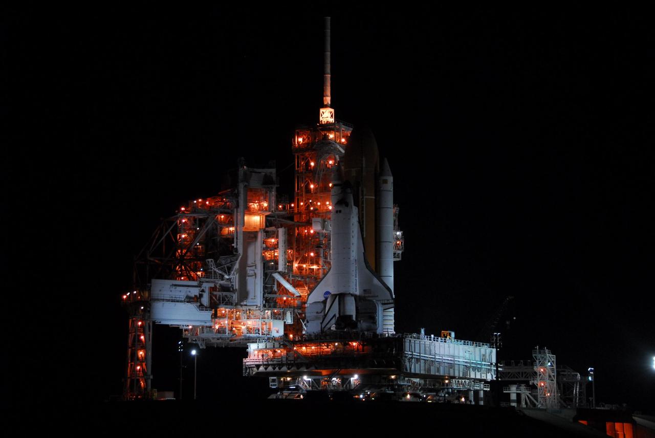 KENNEDY SPACE CENTER, FLA. -- The lighted service structures on Launch Pad 39A cast Space Shuttle Endeavour in shadow after its arrival on Launch Pad 39A after rolling out of the Vehicle Assembly Building. First motion was at 8:10 p.m. July 10 and the shuttle was hard down on the pad at 3:02 a.m. July 11. Endeavour is scheduled to launch on mission STS-118 on Aug. 7. During the mission, Endeavour will carry into orbit the S5 truss, SPACEHAB module and external stowage platform 3. The mission is the 22nd flight to the International Space Station and will mark the first flight of Mission Specialist Barbara Morgan, the teacher-turned-astronaut whose association with NASA began more than 20 years ago. STS-118 will be the first flight since 2002 for Endeavour, which has undergone extensive modifications, including the addition of safety upgrades already added to orbiters Discovery and Atlantis. Photo credit: NASA/George Shelton