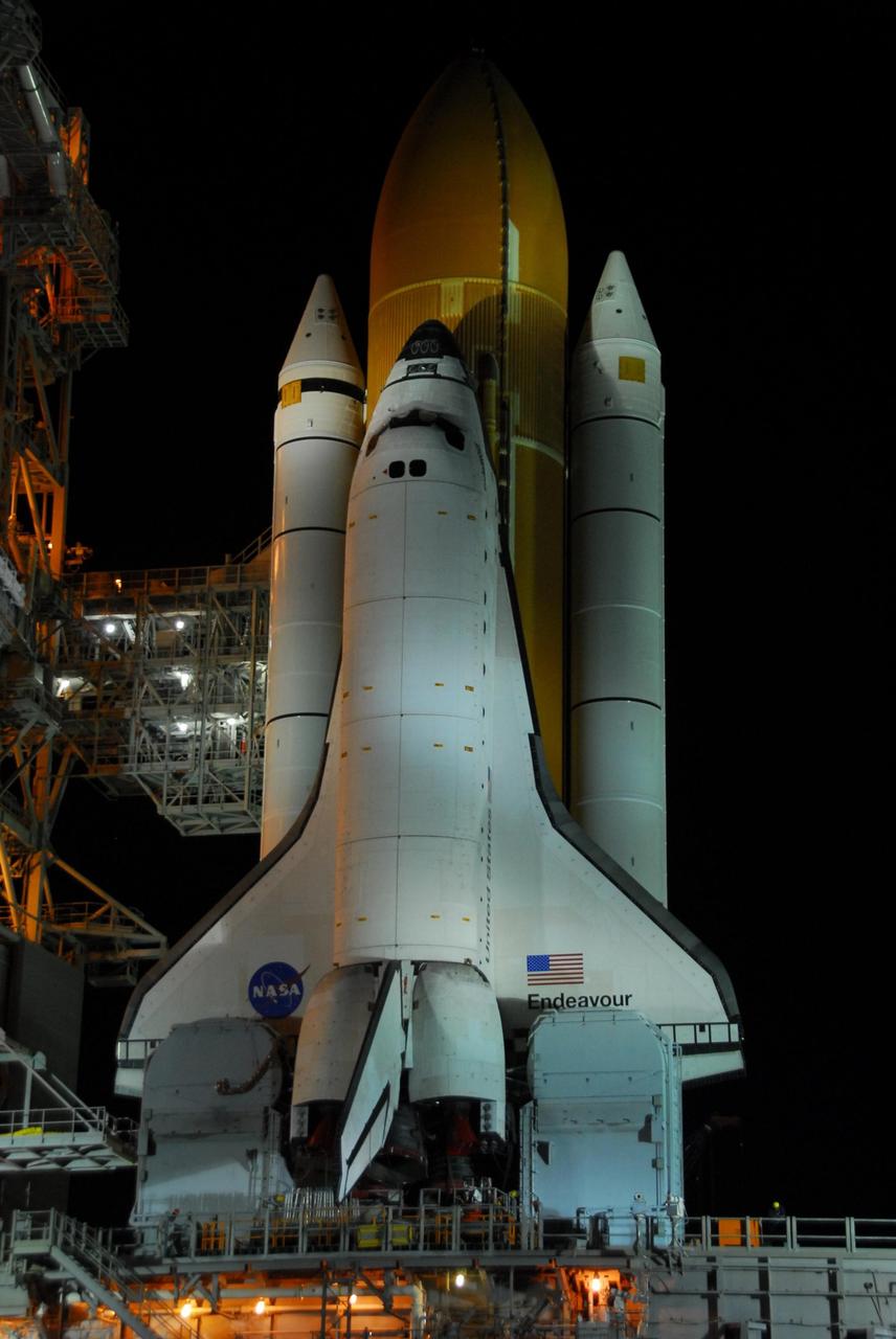 KENNEDY SPACE CENTER, FLA. -- After a nearly 7-hour trip, Space Shuttle Endeavour, atop the mobile launcher platform, is hard down on Launch Pad 39A at 3:02 a.m. First motion out of the Vehicle Assembly Building was at 8:10 p.m. July 10. The components of the shuttle are, first, the orbiter and then the solid rocket boosters flanking the external tank behind it. Seen below the orbiter's wings are the tail masts, which provide several umbilical connections to the orbiter, including a liquid-oxygen line through one and a liquid-hydrogen line through another. Endeavour is scheduled to launch on mission STS-118 on Aug. 7. During the mission, Endeavour will carry into orbit the S5 truss, SPACEHAB module and external stowage platform 3. The mission is the 22nd flight to the International Space Station and will mark the first flight of Mission Specialist Barbara Morgan, the teacher-turned-astronaut whose association with NASA began more than 20 years ago. STS-118 will be the first flight since 2002 for Endeavour, which has undergone extensive modifications, including the addition of safety upgrades already added to orbiters Discovery and Atlantis. Photo credit: NASA/George Shelton