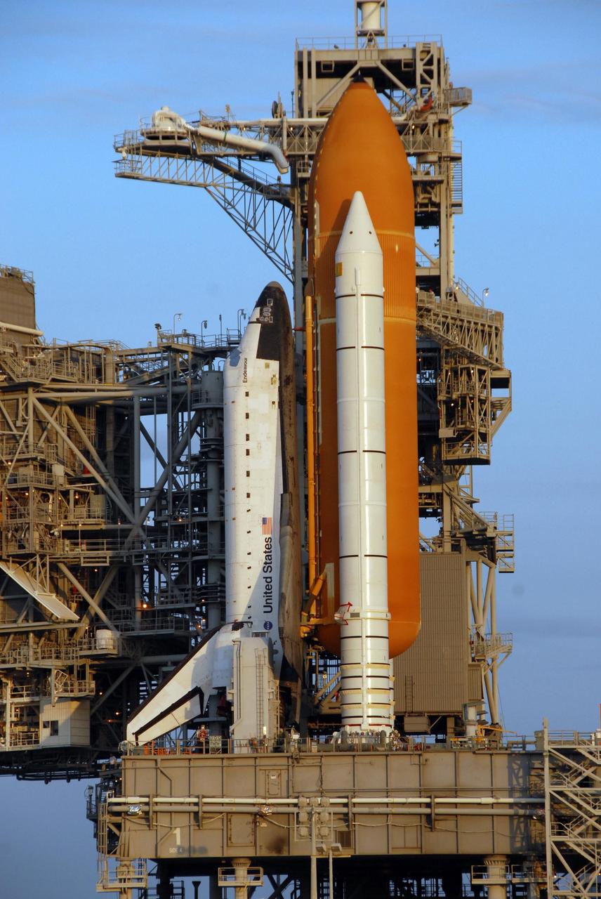 KENNEDY SPACE CENTER, FLA. - This closeup of Space Shuttle Endeavour on Launch Pad 39A shows the orbiter, one solid rocket booster and the external tank that make up the shuttle assembly. Behind the shuttle is the fixed service structure. The shuttle rests on the mobile launcher platform. The shuttle rolled out to the pad overnight. First motion out of the VAB was at 8:10 p.m. July 10, and the shuttle was hard down on the pad at 3:02 a.m. July 11. Endeavour is scheduled to launch on mission STS-118 on Aug. 7. During the mission, Endeavour will carry into orbit the S5 truss, SPACEHAB module and external stowage platform 3. The mission is the 22nd flight to the International Space Station and will mark the first flight of Mission Specialist Barbara Morgan, the teacher-turned-astronaut whose association with NASA began more than 20 years ago. STS-118 will be the first flight since 2002 for Endeavour, which has undergone extensive modifications, including the addition of safety upgrades already added to orbiters Discovery and Atlantis. Photo credit: NASA/Ken Thornsley