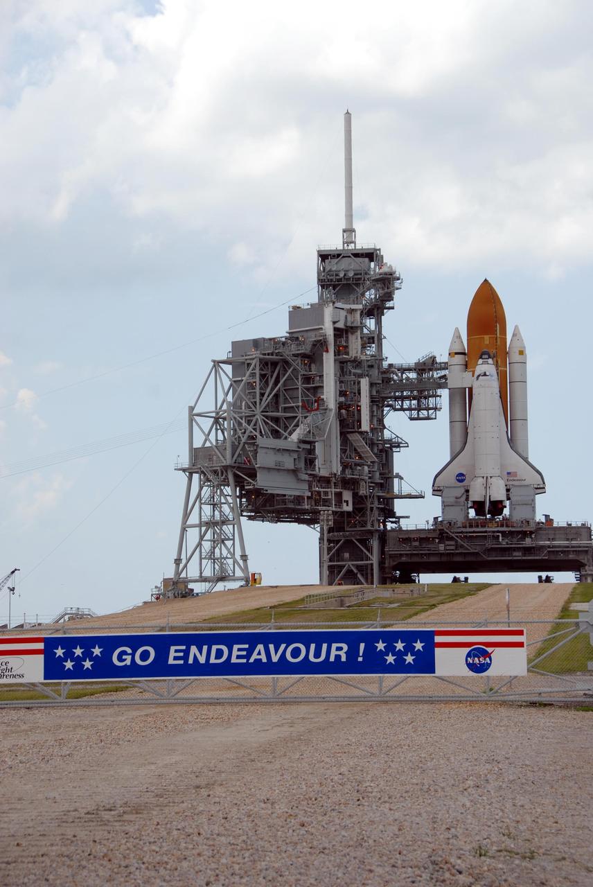 KENNEDY SPACE CENTER, FLA. -- Space Shuttle Endeavour, atop the mobile launcher platform, is hard down on Launch Pad 39A after rolling out overnight. First motion out of the Vehicle Assembly Building was at 8:10 p.m. July 10. The components of the shuttle are, first, the orbiter and then the solid rocket boosters flanking the external tank behind it. To the left of the shuttle is the rotating service structure, which can be rolled around to enclose the vehicle for access during processing. Behind it is the fixed service structure, topped by an 80-foot-tall lightning mast. Extending from it to Endeavour is the orbiter access arm, which provides access into the vehicle. Endeavour is scheduled to launch on mission STS-118 on Aug. 7. During the mission, Endeavour will carry into orbit the S5 truss, SPACEHAB module and external stowage platform 3. The mission is the 22nd flight to the International Space Station and will mark the first flight of Mission Specialist Barbara Morgan, the teacher-turned-astronaut whose association with NASA began more than 20 years ago. STS-118 will be the first flight since 2002 for Endeavour, which has undergone extensive modifications, including the addition of safety upgrades already added to orbiters Discovery and Atlantis. Photo credit: NASA/Ken Thornsley