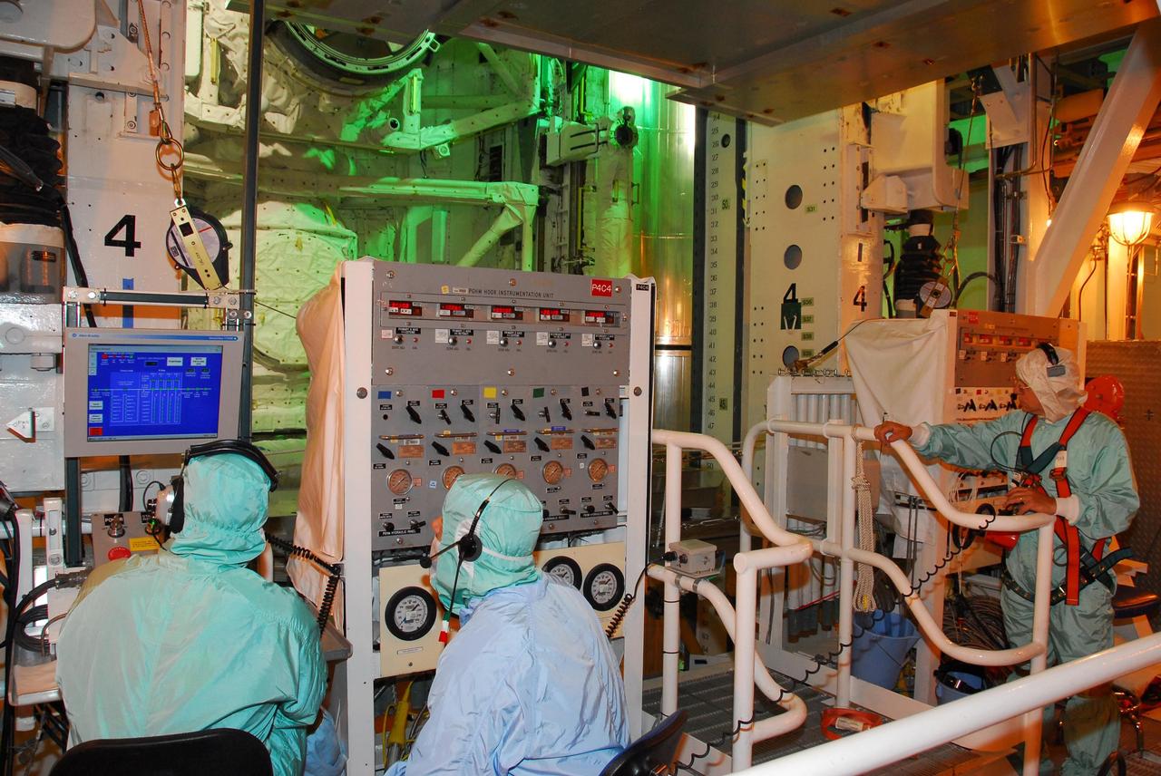 KENNEDY SPACE CENTER, FLA. -- On Launch Pad 39A, workers in the payload changeout room use the payload ground-handling mechanism to transfer the mission STS-118 payload into the payload bay on Space Shuttle Endeavour. The payload includes the S5 truss, the SPACEHAB module and the external stowage platform 3. The mission is the 22nd flight to the International Space Station and is targeted for launch on Aug.7. Photo credit: NASA/Amanda Diller