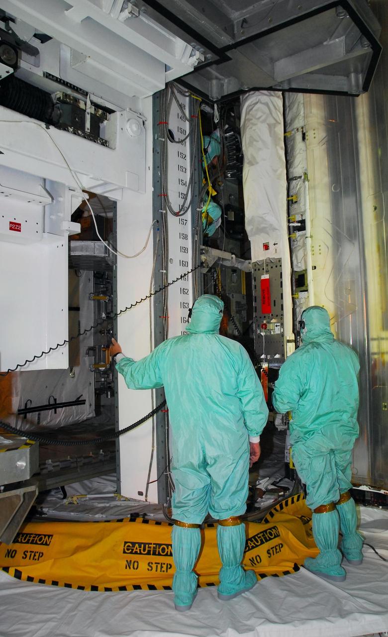 KENNEDY SPACE CENTER, FLA. -- On Launch Pad 39A, workers in the payload changeout room monitor the payload ground-handling mechanism as it transfers the mission STS-118 payload into the payload bay on Space Shuttle Endeavour. The payload includes the S5 truss, the SPACEHAB module and the external stowage platform 3. The mission is the 22nd flight to the International Space Station and is targeted for launch on Aug.7. Photo credit: NASA/Amanda Diller