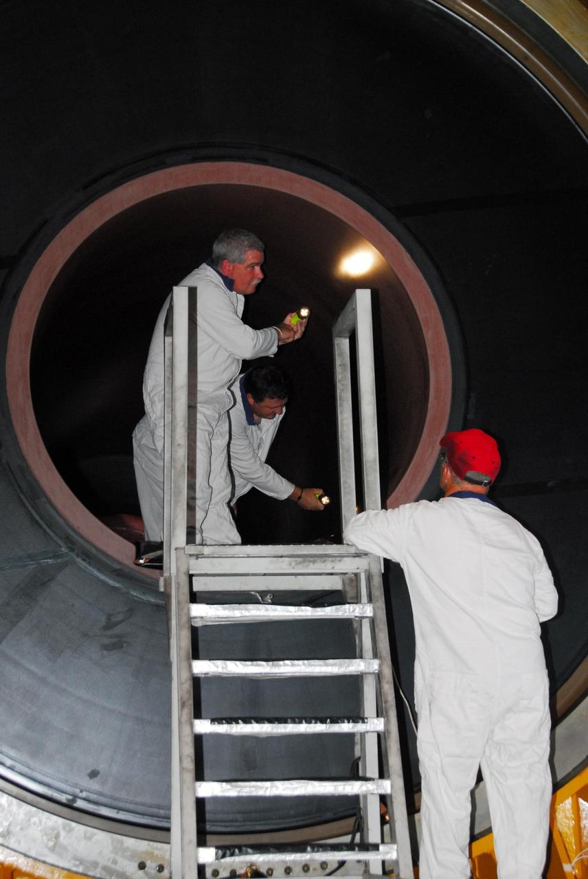 KENNEDY SPACE CENTER, FLA. -- In the Rotation, Processing and Surge Facility, or RSPF, workers conduct propellant grain inspection of the solid rocket booster segment required as part of safety analysis.  The booster segment will be stacked with others to be used on Space Shuttle Atlantis on mission STS-122 targeted for December. The mission will continue assembly of the International Space Station, delivering and installing the Columbus Laboratory.  Photo credit: NASA/George Shelton