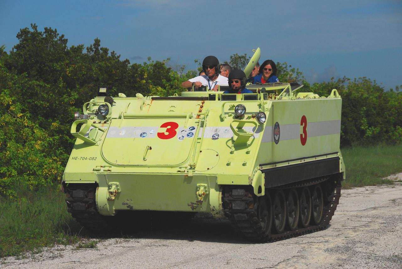 KENNEDY SPACE CENTER, Fla.  --  STS-118 Commander Scott Kelly practices driving an M-113 armored personnel carrier, as part of emergency exit training, with fellow crew members aboard.  Behind Kelly is Mission Specialist Barbara R. Morgan. The crew is at Kennedy for the Terminal Countdown Demonstration Test (TCDT), a dress rehearsal for launch. TCDT activities include the M-113 training, payload familiarization, emergency egress training at the pad and a simulated launch countdown.  The STS-118 payload aboard Space Shuttle Endeavour includes the S5 truss, a SPACEHAB module and external stowage platform 3. The mission is the 22nd flight to the International Space Station and is targeted for launch on Aug.7.  NASA/George Shelton
