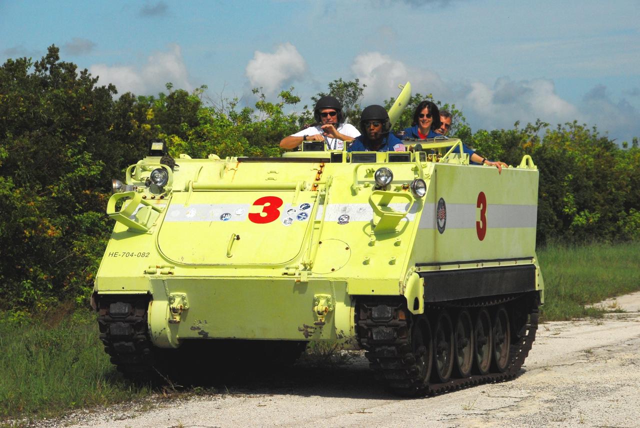 KENNEDY SPACE CENTER, Fla.  --  STS-118 Mission Specialist Alvin Drew practices driving an M-113 armored personnel carrier, with (at right) Mission Specialists Barbara R. Morgan and Dave Williams as passengers. Morgan joined NASA's Teacher in Space program in 1985 and was selected as an astronaut in 1998.  Williams represents the Canadian Space Agency.  They and other crew members are at Kennedy for the Terminal Countdown Demonstration Test (TCDT), a dress rehearsal for launch. TCDT activities include the M-113 training, payload familiarization, emergency egress training at the pad and a simulated launch countdown.  The STS-118 payload aboard Space Shuttle Endeavour includes the S5 truss, a SPACEHAB module and external stowage platform 3. The mission is the 22nd flight to the International Space Station and is targeted for launch on Aug.7.  NASA/George Shelton