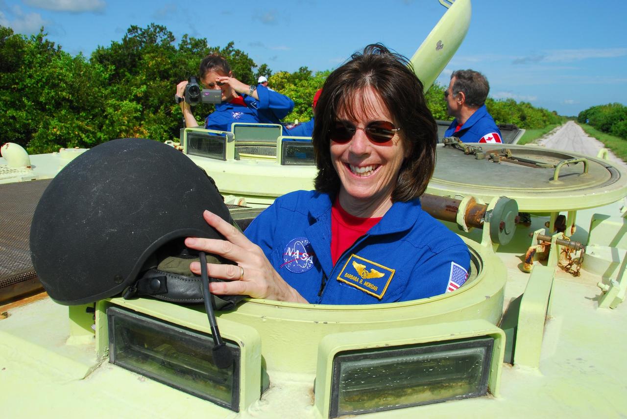 KENNEDY SPACE CENTER, Fla.  --  STS-118 Mission Specialist Barbara R. Morgan is ready to practice driving an M-113 armored personnel carrier as part of emergency exit training.  Behind her at the rear are Mission Specialists (left) Tracy Caldwell and Dave Williams.  Morgan joined NASA's Teacher in Space program in 1985 and was selected as an astronaut in 1998. She and other crew members are at Kennedy for the Terminal Countdown Demonstration Test (TCDT), a dress rehearsal for launch.  TCDT activities include the M-113 training, payload familiarization, emergency egress training at the pad and a simulated launch countdown.  The STS-118 payload aboard Space Shuttle Endeavour includes the S5 truss, a SPACEHAB module and external stowage platform 3. The mission is the 22nd flight to the International Space Station and is targeted for launch on Aug.7.  NASA/George Shelton