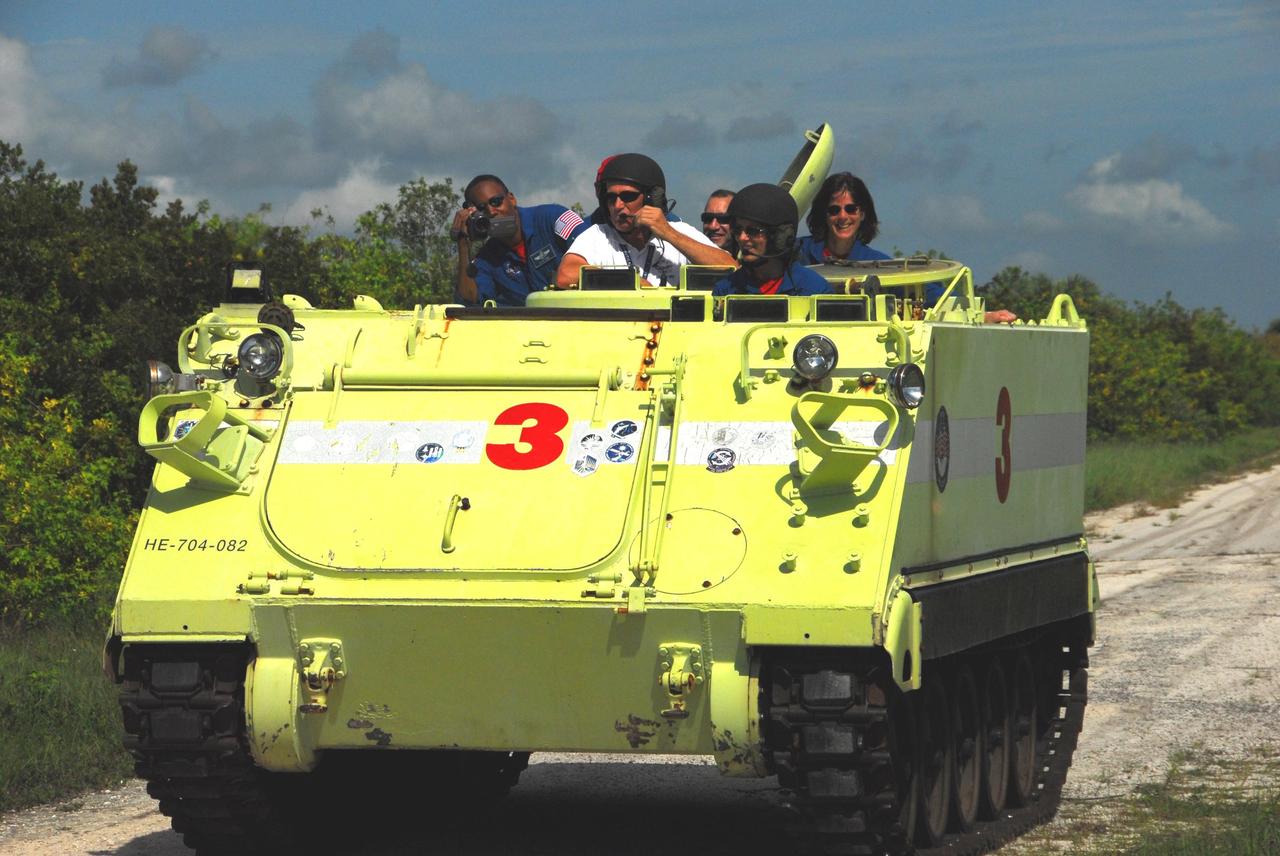 KENNEDY SPACE CENTER, Fla.  --  STS-118 Mission Specialist Tracy Caldwell practices driving an M-113 armored personnel carrier as part of emergency exit training.  Seen in the back are Mission Specialist Alvin Drew, Pilot Charlie Hobaugh and educator astronaut and Mission Specialist Barbara R. Morgan.  They and other crew members are at Kennedy for the Terminal Countdown Demonstration Test (TCDT), a dress rehearsal for launch.  TCDT activities include the M-113 training, payload familiarization, emergency egress training at the pad and a simulated launch countdown.  The STS-118 payload aboard Space Shuttle Endeavour includes the S5 truss, a SPACEHAB module and external stowage platform 3. The mission is the 22nd flight to the International Space Station and is targeted for launch on Aug.7.  NASA/George Shelton