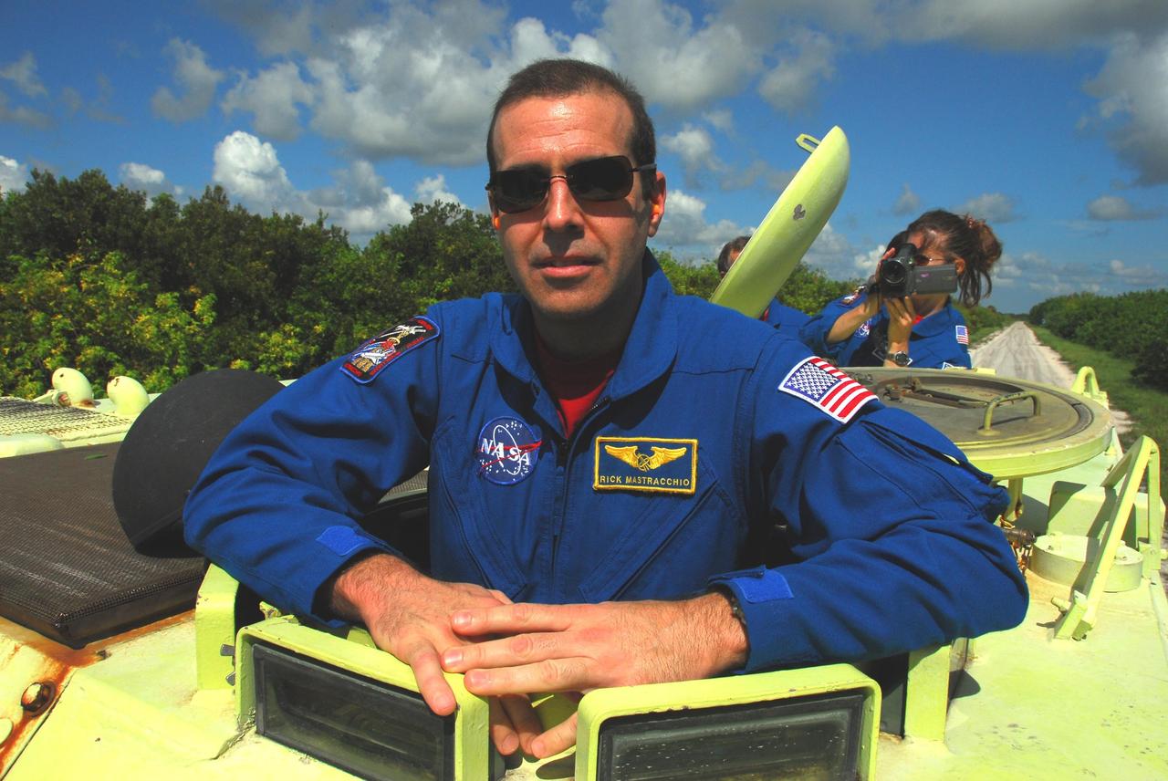 KENNEDY SPACE CENTER, Fla.  --  STS-118 Mission Specialist Rick Mastracchio gets ready to practice driving an M-113 armored personnel carrier as part of emergency exit training.  Behind him, at right, is Mission Specialist Tracy Caldwell.  They and other crew members are at Kennedy for the Terminal Countdown Demonstration Test (TCDT), a dress rehearsal for launch. TCDT activities include the M-113 training, payload familiarization, emergency egress training at the pad and a simulated launch countdown.  The STS-118 payload aboard Space Shuttle Endeavour includes the S5 truss, a SPACEHAB module and external stowage platform 3. The mission is the 22nd flight to the International Space Station and is targeted for launch on Aug.7.  NASA/George Shelton