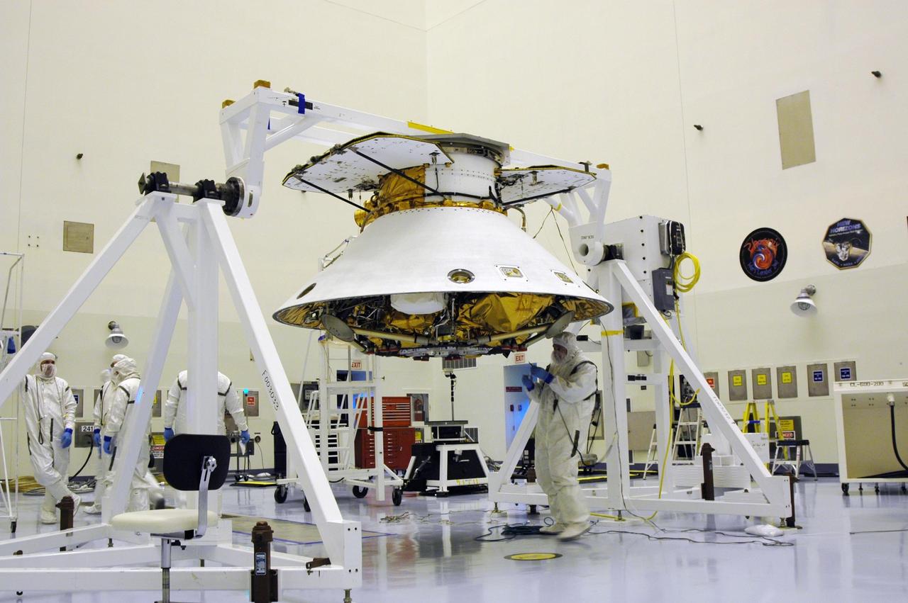 KENNEDY SPACE CENTER, Fla. -- In the Payload Hazardous Servicing Facility, workers prepare the Phoenix Mars Lander spacecraft for rotation. After rotation, the Phoenix will be mated with the upper stage booster. Targeted for launch from Cape Canaveral Air Force Station on Aug. 3, Phoenix will land in icy soils near the north polar permanent ice cap of Mars and explore the history of the water in these soils and any associated rocks, while monitoring polar climate. Landing on Mars is planned in May 2008 on arctic ground where a mission currently in orbit, Mars Odyssey, has detected high concentrations of ice just beneath the top layer of soil. NASA/Dimitri Gerondidakis