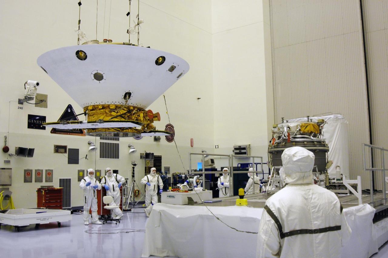 KENNEDY SPACE CENTER, Fla. -- In the Payload Hazardous Servicing Facility, the Phoenix Mars Lander spacecraft is moved across the area toward the upper stage booster at right. The spacecraft and booster will be mated for launch. Targeted for launch from Cape Canaveral Air Force Station on Aug. 3, Phoenix will land in icy soils near the north polar permanent ice cap of Mars and explore the history of the water in these soils and any associated rocks, while monitoring polar climate. Landing on Mars is planned in May 2008 on arctic ground where a mission currently in orbit, Mars Odyssey, has detected high concentrations of ice just beneath the top layer of soil. NASA/Dimitri Gerondidakis