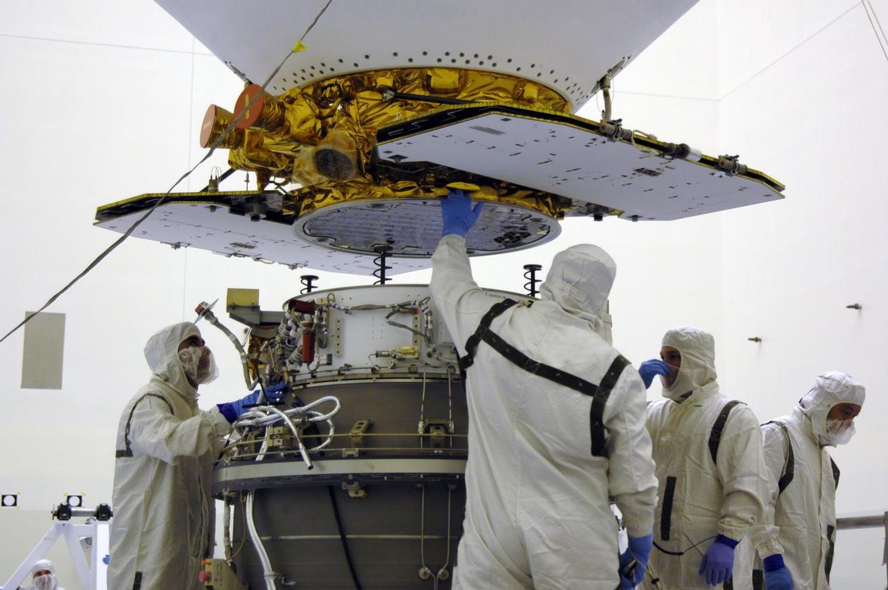 KENNEDY SPACE CENTER, Fla.  --  In the Payload Hazardous Servicing Facility, workers help guide the suspended Phoenix Mars Lander spacecraft being lowered toward the upper stage booster.  The spacecraft and booster will be mated for launch. Targeted for launch from Cape Canaveral Air Force Station on Aug. 3, Phoenix will land in icy soils near the north polar permanent ice cap of Mars and explore the history of the water in these soils and any associated rocks, while monitoring polar climate. Landing on Mars is planned in May 2008 on arctic ground where a mission currently in orbit, Mars Odyssey, has detected high concentrations of ice just beneath the top layer of soil.  NASA/Dimitri Gerondidakis