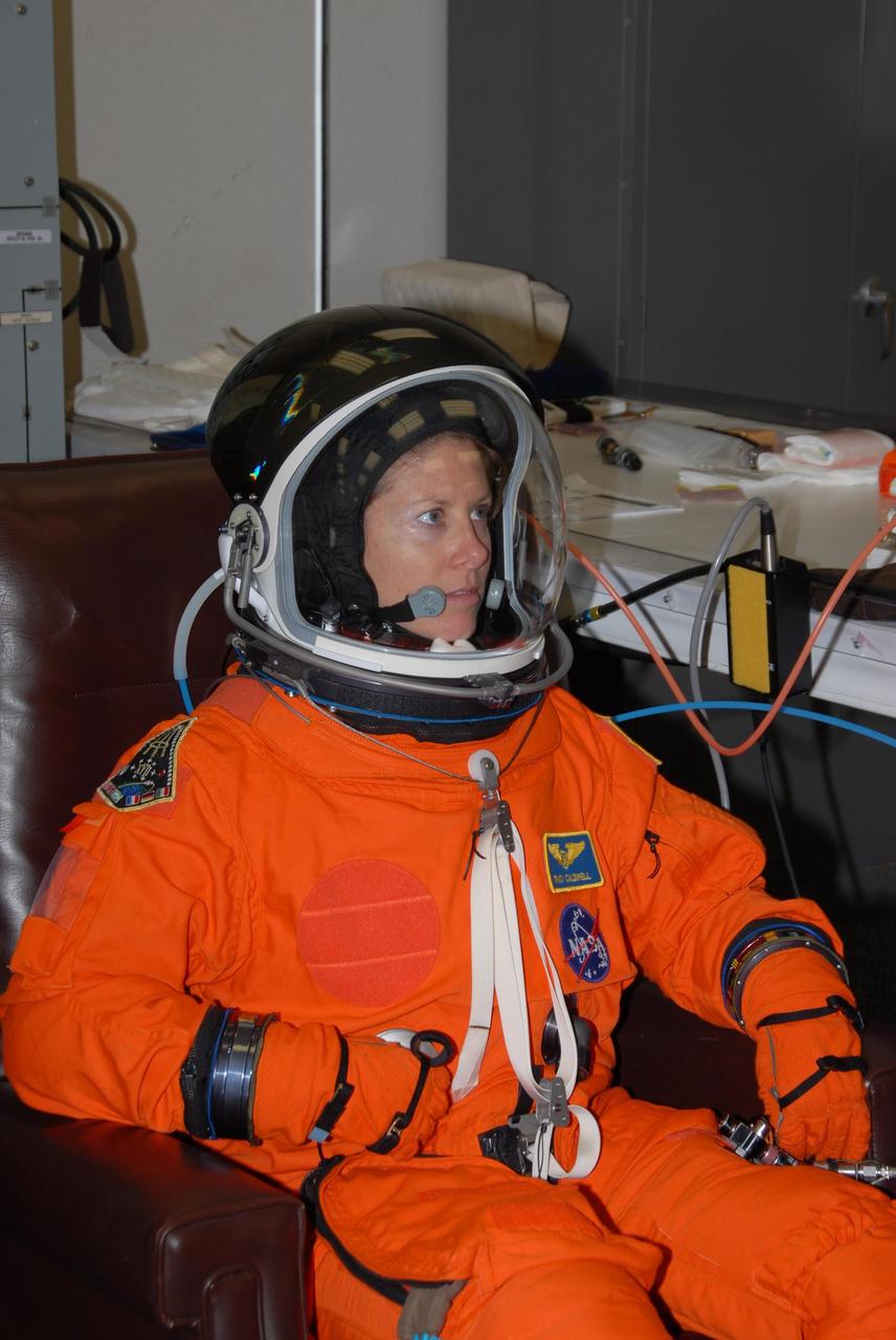 KENNEDY SPACE CENTER, Fla. -- STS-118 Mission Specialist Tracy Caldwell tests the fit of her helmet and launch and entry suit during Terminal Countdown Demonstration Test (TCDT) activities, a dress rehearsal for launch. TCDT activities include the M-113 training, payload familiarization, emergency egress training at the pad and a simulated launch countdown. The STS-118 payload aboard Space Shuttle Endeavour includes the S5 truss, a SPACEHAB module and external stowage platform 3. The mission is the 22nd flight to the International Space Station and is targeted for launch on Aug. 7. NASA/George Shelton
