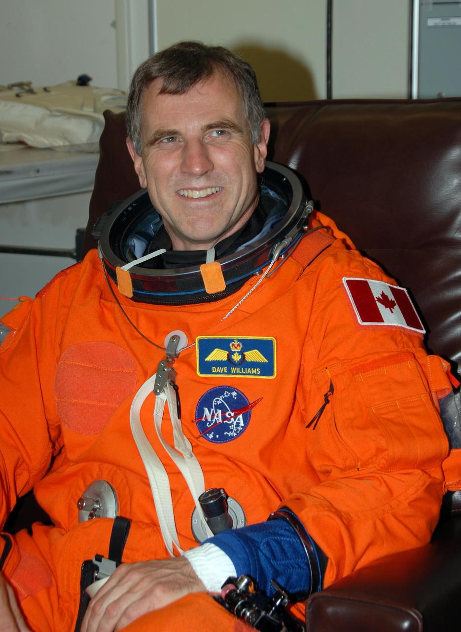 KENNEDY SPACE CENTER, Fla. -- STS-118 Mission Specialist Dave Williams tests the fit of his launch and entry suit during Terminal Countdown Demonstration Test (TCDT) activities, a dress rehearsal for launch. TCDT activities include the M-113 training, payload familiarization, emergency egress training at the pad and a simulated launch countdown. The STS-118 payload aboard Space Shuttle Endeavour includes the S5 truss, a SPACEHAB module and external stowage platform 3. The mission is the 22nd flight to the International Space Station and is targeted for launch on Aug. 7. NASA/George Shelton