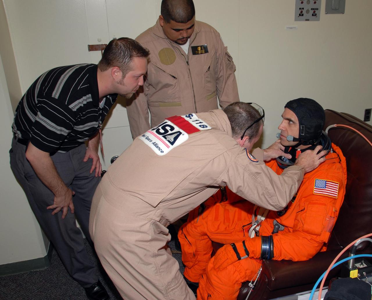 KENNEDY SPACE CENTER, Fla. -- STS-118 Mission Specialist Rick Mastracchio gets help with the fit of his launch and entry suit during Terminal Countdown Demonstration Test (TCDT) activities, a dress rehearsal for launch. TCDT activities include the M-113 training, payload familiarization, emergency egress training at the pad and a simulated launch countdown. The STS-118 payload aboard Space Shuttle Endeavour includes the S5 truss, a SPACEHAB module and external stowage platform 3. The mission is the 22nd flight to the International Space Station and is targeted for launch on Aug. 7. NASA/George Shelton