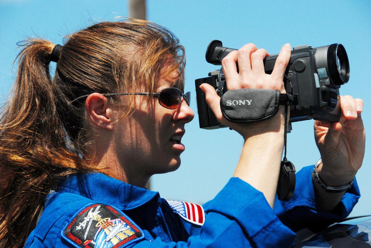 KENNEDY SPACE CENTER, Fla. -- Near Launch Pad 39A, STS-118 Mission Specialist Tracy Caldwell practices using a video camera to film the external tank/solid rocket booster stack on Space Shuttle Endeavour. Caldwell will capture the separation of the tank from Endeavour after launch. The STS-118 crew is at Kennedy to take part in Terminal Countdown Demonstration Test activities, including M-113 training, payload familiarization, emergency egress training at the pad and a simulated launch countdown. The payload aboard Space Shuttle Endeavour includes the S5 truss, a SPACEHAB module and external stowage platform 3. The STS-118 mission is the 22nd flight to the International Space Station and is targeted for launch on Aug. 7. NASA/George Shelton