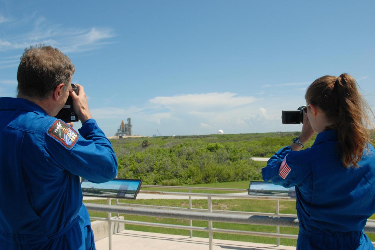 KENNEDY SPACE CENTER, Fla.  --  From the viewing site near Launch Pad 39A, STS-118 Mission Specialists Dave Williams and Tracy Caldwell practice using their respective cameras to capture images of the external tank/solid rocket booster stack on Space Shuttle Endeavour. They will capture the separation of the tank from Endeavour after launch. The STS-118 crew is at Kennedy to take part in Terminal Countdown Demonstration Test activities, including M-113 training, payload familiarization, emergency egress training at the pad and a simulated launch countdown. The payload aboard Space Shuttle Endeavour includes the S5 truss, a SPACEHAB module and external stowage platform 3. The STS-118 mission is the 22nd flight to the International Space Station and is targeted for launch on Aug. 7.  NASA/George Shelton