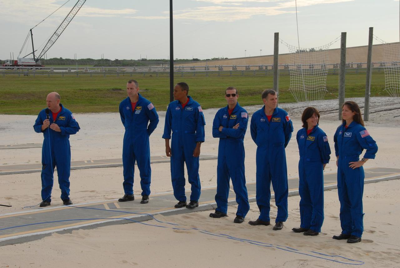 KENNEDY SPACE CENTER, Fla.  --  On the slidewire basket bunker area of Launch Pad 39A, the STS-118 crew talks to the media before the crew's morning training activities in the terminal countdown demonstration test, or TCDT.  At left is Commander Scott Kelly, with the microphone.  The others, from left, are Pilot Charlie Hobaugh and Mission Specialists Alvin Drew, Rick Mastracchio, Dave Williams, Barbara R. Morgan and Tracy Caldwell.  Williams represents the Canadian Space Agency.  Morgan joined NASA's Teacher in Space program in 1985 and was selected as an astronaut in 1998.  TCDT activities include M-113 training, payload familiarization, the emergency egress training at the pad and a simulated launch countdown.  The mission is the 22nd flight to the International Space Station and Space Shuttle Endeavour will carry a payload including the S5 truss, a SPACEHAB module and external stowage platform 3. STS-118 is targeted for launch on Aug. 7.  NASA/George Shelton