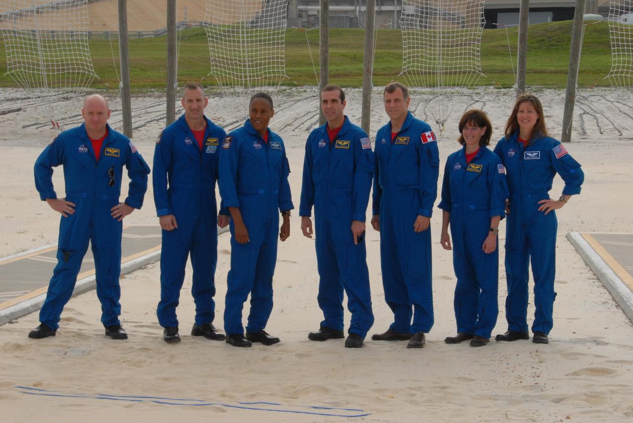 KENNEDY SPACE CENTER, Fla.  --  On the slidewire basket bunker area of Launch Pad 39A, the STS-118 crew greets the media before the crew's morning training activities in the terminal countdown demonstration test, or TCDT.  From left are Commander Scott Kelly, Pilot Charlie Hobaugh and Mission Specialists Alvin Drew, Rick Mastracchio, Dave Williams, Barbara R. Morgan and Tracy Caldwell. Williams represents the Canadian Space Agency.  Morgan joined NASA's Teacher in Space program in 1985 and was selected as an astronaut in 1998. TCDT activities include M-113 training, payload familiarization, the emergency egress training at the pad and a simulated launch countdown.  The mission is the 22nd flight to the International Space Station and Space Shuttle Endeavour will carry a payload including the S5 truss, a SPACEHAB module and external stowage platform 3. STS-118 is targeted for launch on Aug. 7.  NASA/George Shelton