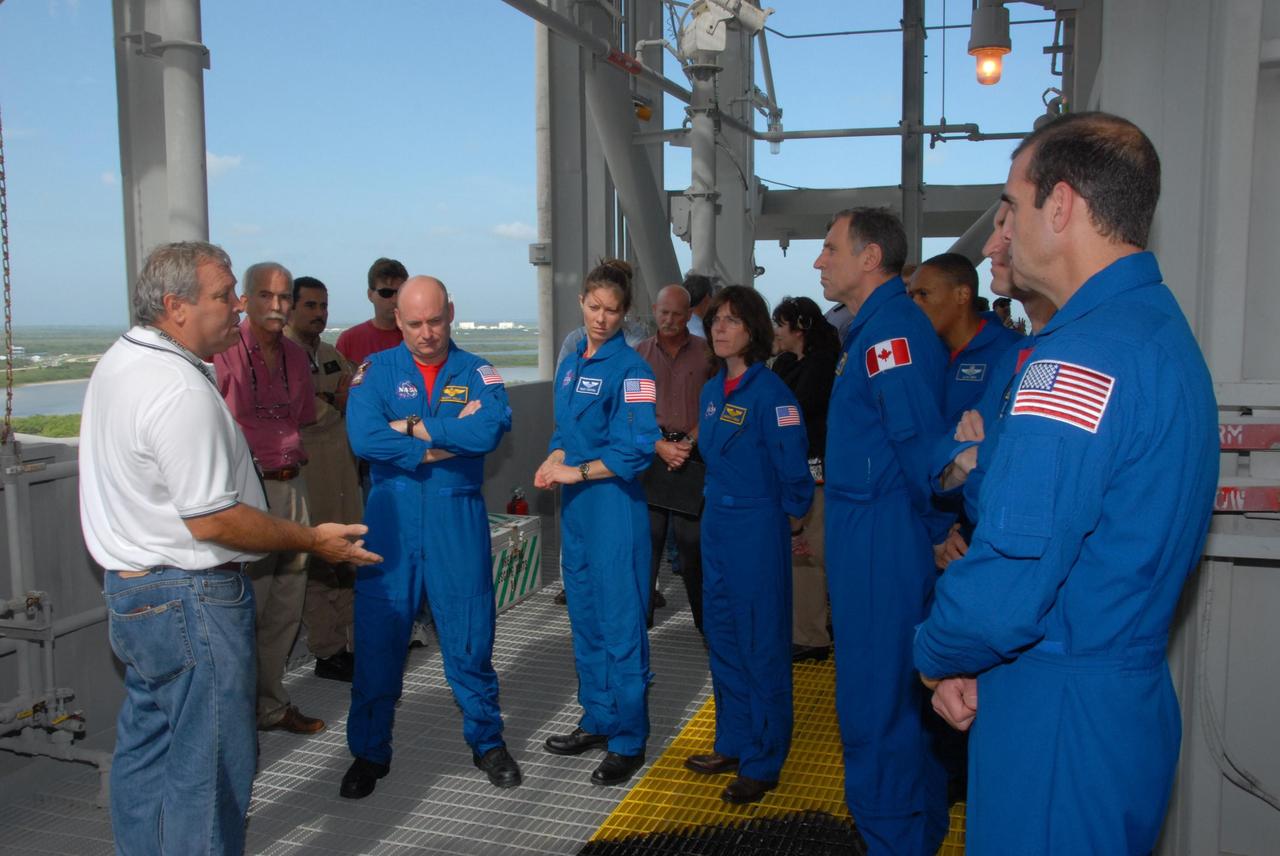 KENNEDY SPACE CENTER, Fla.  --   On an upper level of the Pad 39A fixed service structure, the STS-118 crew listen to a trainer, at left, about using the emergency egress system.  The crew members are, from left, Commander Scott Kelly, Mission Specialists Tracy Caldwell, Barbara R. Morgan, Dave Williams and Alvin Drew, Pilot Charlie Hobaugh and Mission Specialist Rick Mastracchio. Williams represents the Canadian Space Agency. Morgan joined NASA's Teacher in Space program in 1985 and was selected as an astronaut in 1998. The crew is at Kennedy for training activities in the terminal countdown demonstration test, or TCDT.  TCDT activities include M-113 training, payload familiarization, the emergency egress training at the pad and a simulated launch countdown.  The mission is the 22nd flight to the International Space Station and Space Shuttle Endeavour will carry a payload including the S5 truss, a SPACEHAB module and external stowage platform 3. STS-118 is targeted for launch on Aug. 7.  NASA/George Shelton