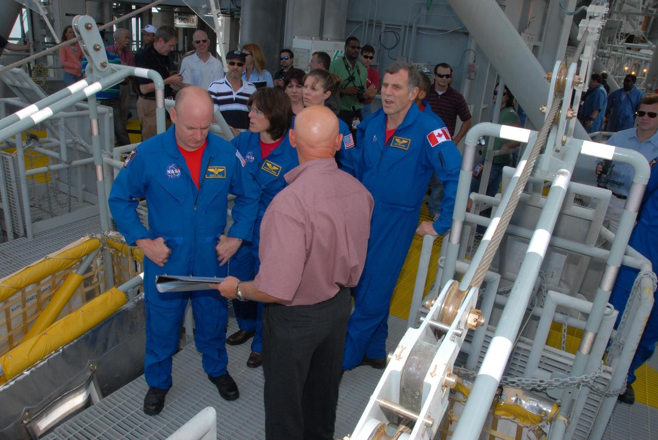 KENNEDY SPACE CENTER, Fla.  --    On an upper level of the Pad 39A fixed service structure, the STS-118 crew get instructions from a trainer about using the emergency egress system.  The crew members seen here are, from left, Commander Scott Kelly and Mission Specialists Barbara R. Morgan, Tracy Caldwell and Dave Williams. Morgan joined NASA's Teacher in Space program in 1985 and was selected as an astronaut in 1998.  Williams represents the Canadian Space Agency. The crew is at Kennedy for training activities in the terminal countdown demonstration test, or TCDT. TCDT activities include M-113 training, payload familiarization, the emergency egress training at the pad and a simulated launch countdown.  The mission is the 22nd flight to the International Space Station and Space Shuttle Endeavour will carry a payload including the S5 truss, a SPACEHAB module and external stowage platform 3. STS-118 is targeted for launch on Aug. 7.  NASA/George Shelton