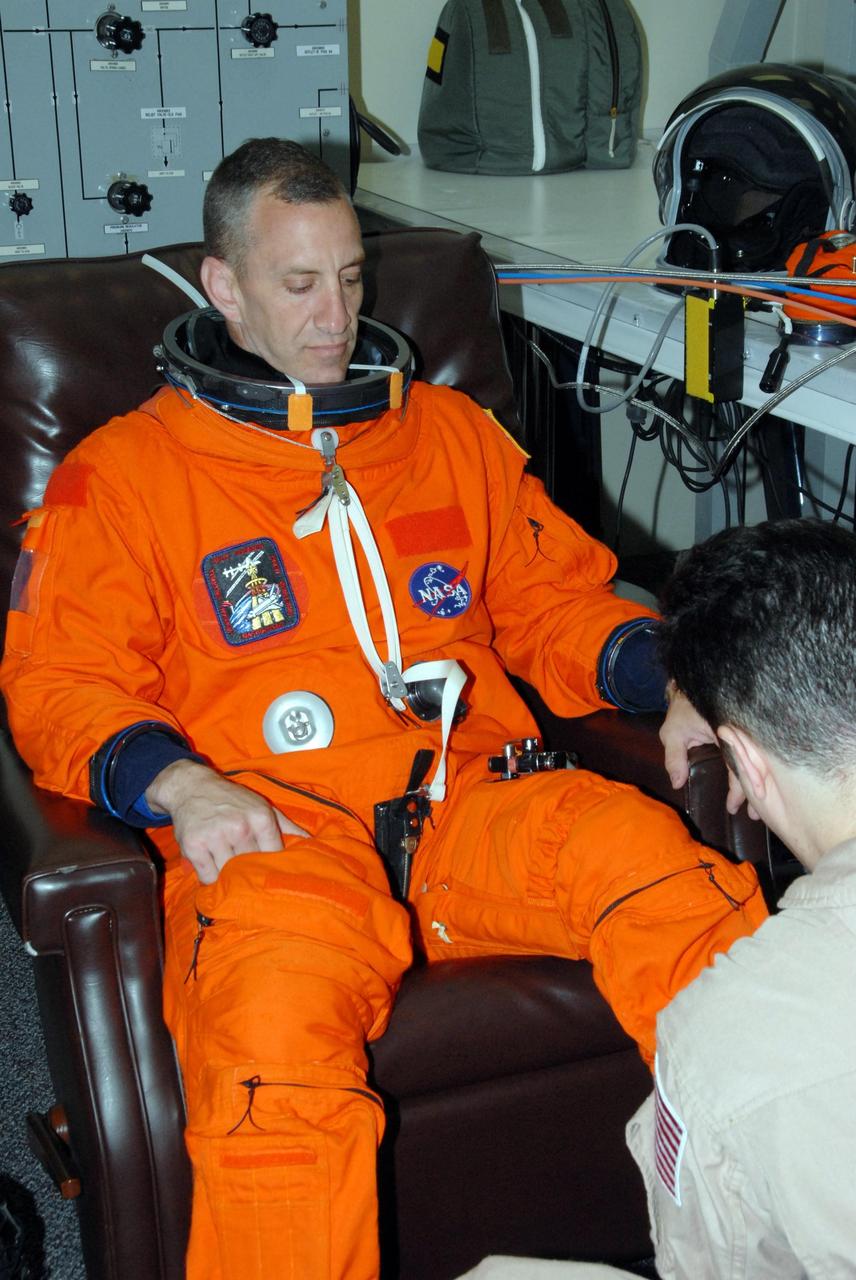 KENNEDY SPACE CENTER, Fla.  --  STS-118 Pilot Charlie Hobaugh suits up for the simulated launch countdown that concludes the terminal countdown demonstration test, or TCDT. The STS-118 crew has been at Kennedy for the TCDT activities that also include M-113 training, payload familiarization and emergency egress training at the pad.  The mission is the 22nd flight to the International Space Station and Space Shuttle Endeavour will carry a payload including the S5 truss, a SPACEHAB module and external stowage platform 3. STS-118 is targeted for launch on Aug. 7.  Photo credit: NASA/George Shelton