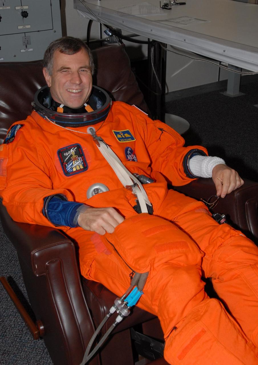 KENNEDY SPACE CENTER, Fla.  --  STS-118 Mission Specialist Dave Williams, who represents the Canadian Space Agency, completes suitup before the simulated launch countdown that concludes the terminal countdown demonstration test, or TCDT. The STS-118 crew has been at Kennedy for the TCDT activities that also include M-113 training, payload familiarization and emergency egress training at the pad.  The mission is the 22nd flight to the International Space Station and Space Shuttle Endeavour will carry a payload including the S5 truss, a SPACEHAB module and external stowage platform 3. STS-118 is targeted for launch on Aug. 7.  Photo credit: NASA/George Shelton