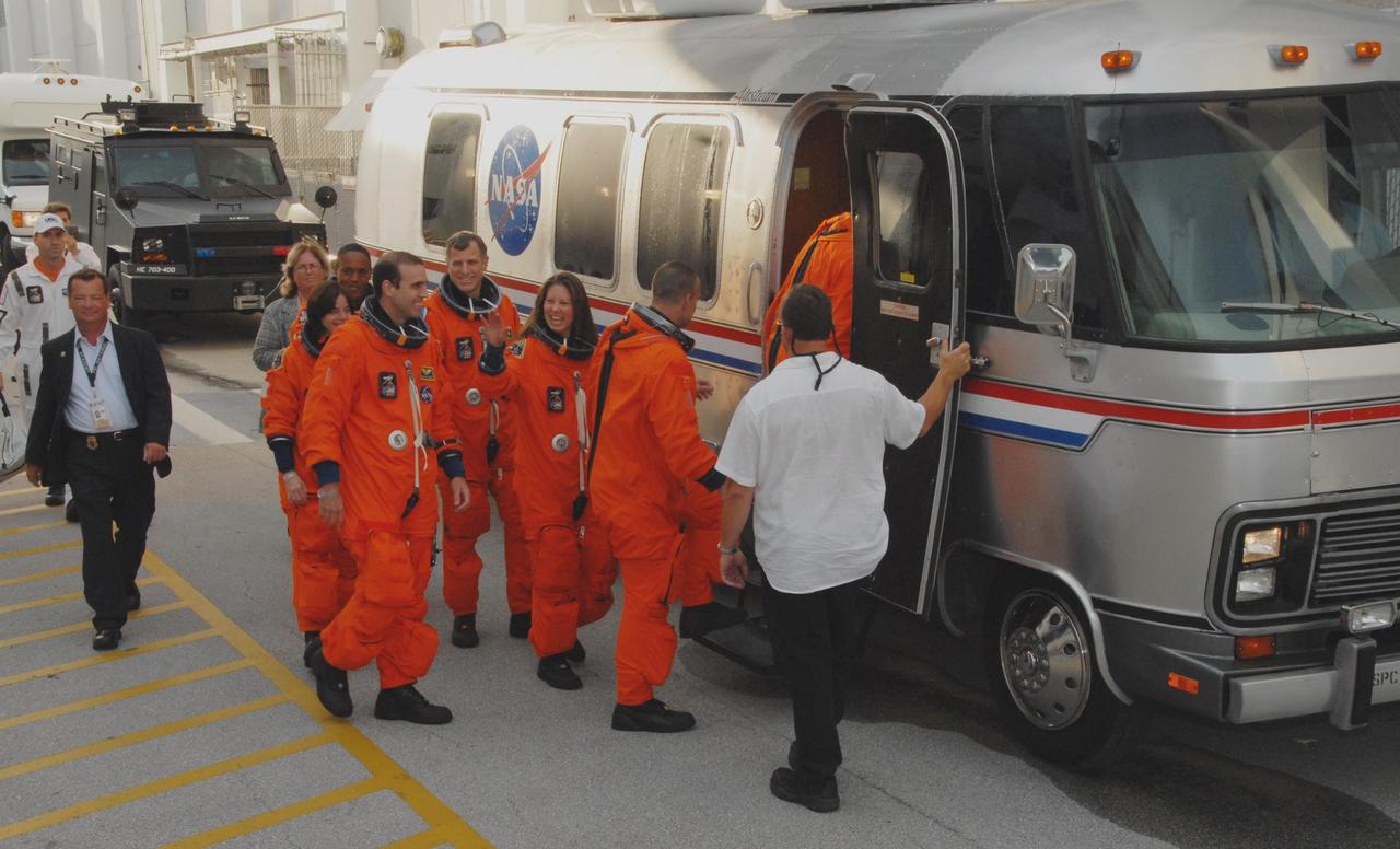 KENNEDY SPACE CENTER, Fla.  -- The STS-118 crew heads into the Astrovan that will take them to Launch Pad 39A for a simulated launch countdown. First in is Commander Scott Kelly.  Following, right to left, are Pilot Charlie Hobaugh and Mission Specialists Tracy Caldwell, Dave Williams, Rick Mastracchio, teacher-turned-astronaut Barbara R. Morgan and Alvin Drew.  The countdown concludes the terminal countdown demonstration test, or TCDT. The STS-118 crew has been at Kennedy for the TCDT activities that also include M-113 training, payload familiarization and emergency egress training at the pad.  The mission is the 22nd flight to the International Space Station and Space Shuttle Endeavour will carry a payload including the S5 truss, a SPACEHAB module and external stowage platform 3. STS-118 is targeted for launch on Aug. 7.  Photo credit: NASA/George Shelton