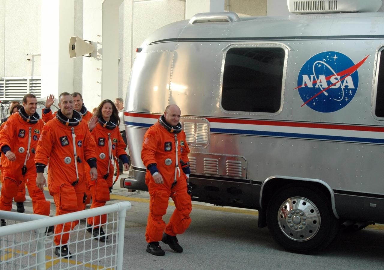 KENNEDY SPACE CENTER, Fla.  -- The STS-118 crew walks toward the Astrovan that will take them to Launch Pad 39A for a simulated launch countdown.  From left are Mission Specialists Barbara R. Morgan and Rick Mastracchio, Pilot Charlie Hobaugh, Mission Specialists Dave Williams and Tracy Caldwell, and Commander Scott Kelly.  Morgan joined NASA's Teacher in Space program in 1985 and was selected as an astronaut in 1998. The countdown concludes the terminal countdown demonstration test, or TCDT. The STS-118 crew has been at Kennedy for the TCDT activities that also include M-113 training, payload familiarization and emergency egress training at the pad.  The mission is the 22nd flight to the International Space Station and Space Shuttle Endeavour will carry a payload including the S5 truss, a SPACEHAB module and external stowage platform 3. STS-118 is targeted for launch on Aug. 7.  Photo credit: NASA/George Shelton