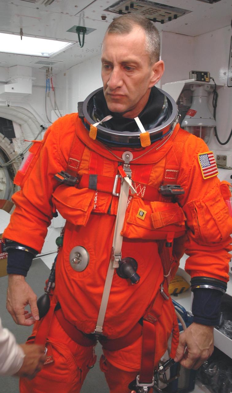KENNEDY SPACE CENTER, Fla.  --  In the White Room on Launch Pad 39A, STS-118 Pilot Charlie Hobaugh waits for the closeout crew to finish checking his launch and entry suit before he enters Space Shuttle Endeavour.  Hobaugh and the rest of the crew are taking part in a simulated launch countdown, the culmination of terminal countdown demonstration test activities.  The White Room is situated at the end of the orbiter access arm and provides entry into the orbiter. TCDT activities also include M-113 training, payload familiarization and emergency egress training at the pad.  The mission is the 22nd flight to the International Space Station and Space Shuttle Endeavour will carry a payload including the S5 truss, a SPACEHAB module and external stowage platform 3. STS-118 is targeted for launch on Aug. 7.  Photo credit: NASA/Amanda Diller