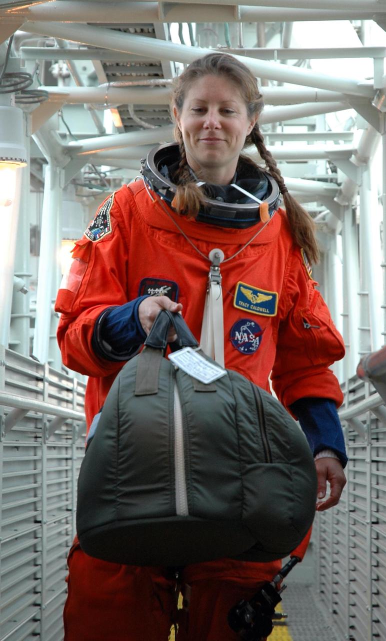 KENNEDY SPACE CENTER, Fla. -- On Launch Pad 39A, STS-118 Mission Specialist Tracy Caldwell makes her way to the White Room. There she will have her launch and entry suit prepared for liftoff by the closeout crew. Caldwell and the rest of the crew are taking part n a simulated launch countdown, the culmination of terminal countdown demonstration test activities. The White Room is situated at the end of the orbiter access arm and provides entry into the orbiter. TCDT activities also include M-113 training, payload familiarization and emergency egress training at the pad. The mission is the 22nd flight to the International Space Station and Space Shuttle Endeavour will carry a payload including the S5 truss, a SPACEHAB module and external stowage platform 3. STS-118 is targeted for launch on Aug. 7. Photo credit: NASA/Amanda Diller